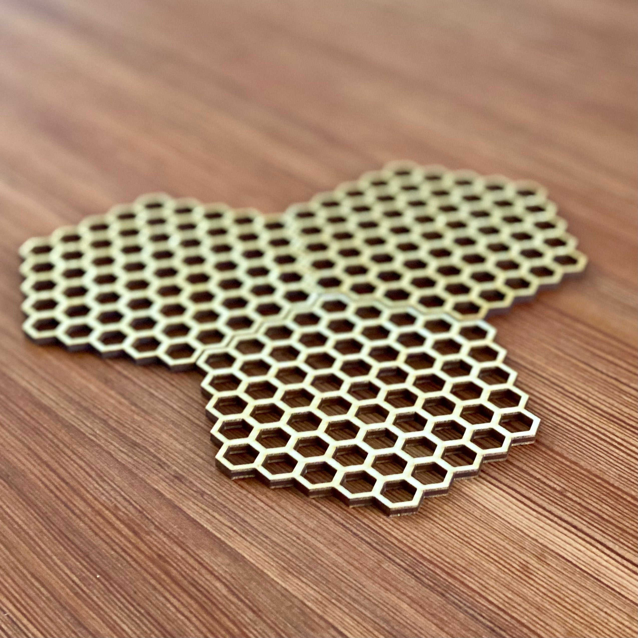 A set of honeycomb laser cut wood coasters made from high-quality birch plywood, showcasing a unique hexagonal design.