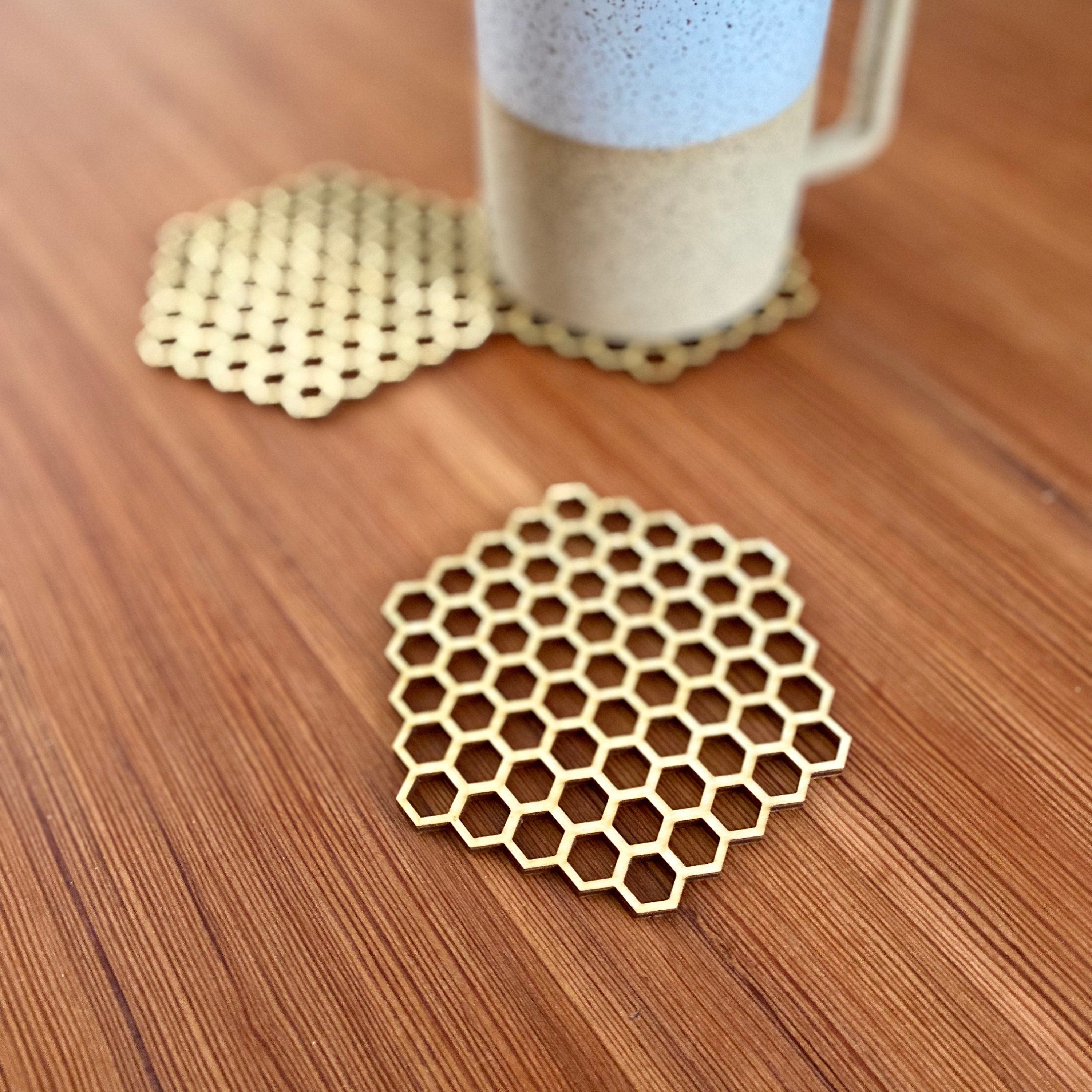 A set of honeycomb laser cut wood coasters made from high-quality birch plywood, showcasing a unique hexagonal design.