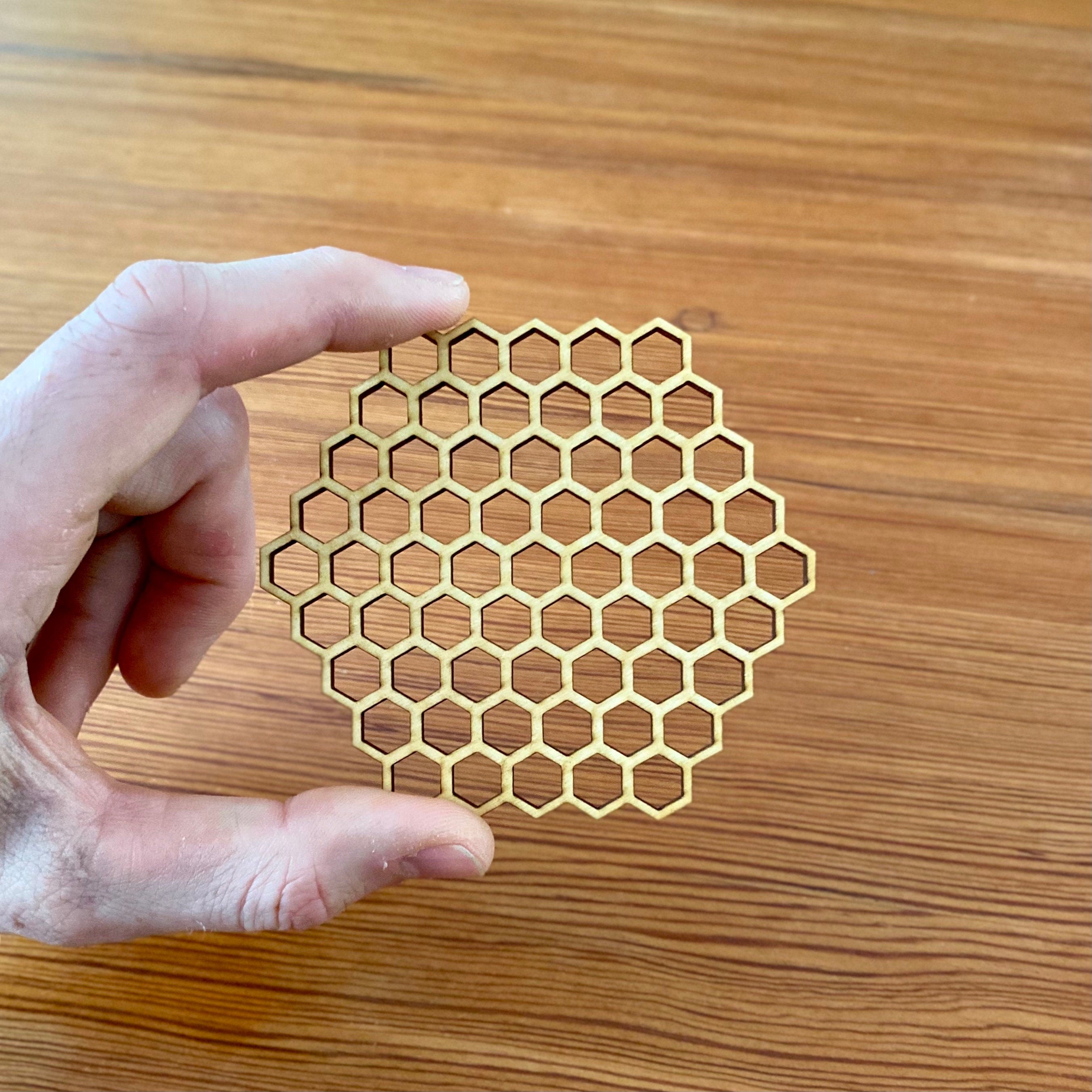 A set of honeycomb laser cut wood coasters made from high-quality birch plywood, showcasing a unique hexagonal design.