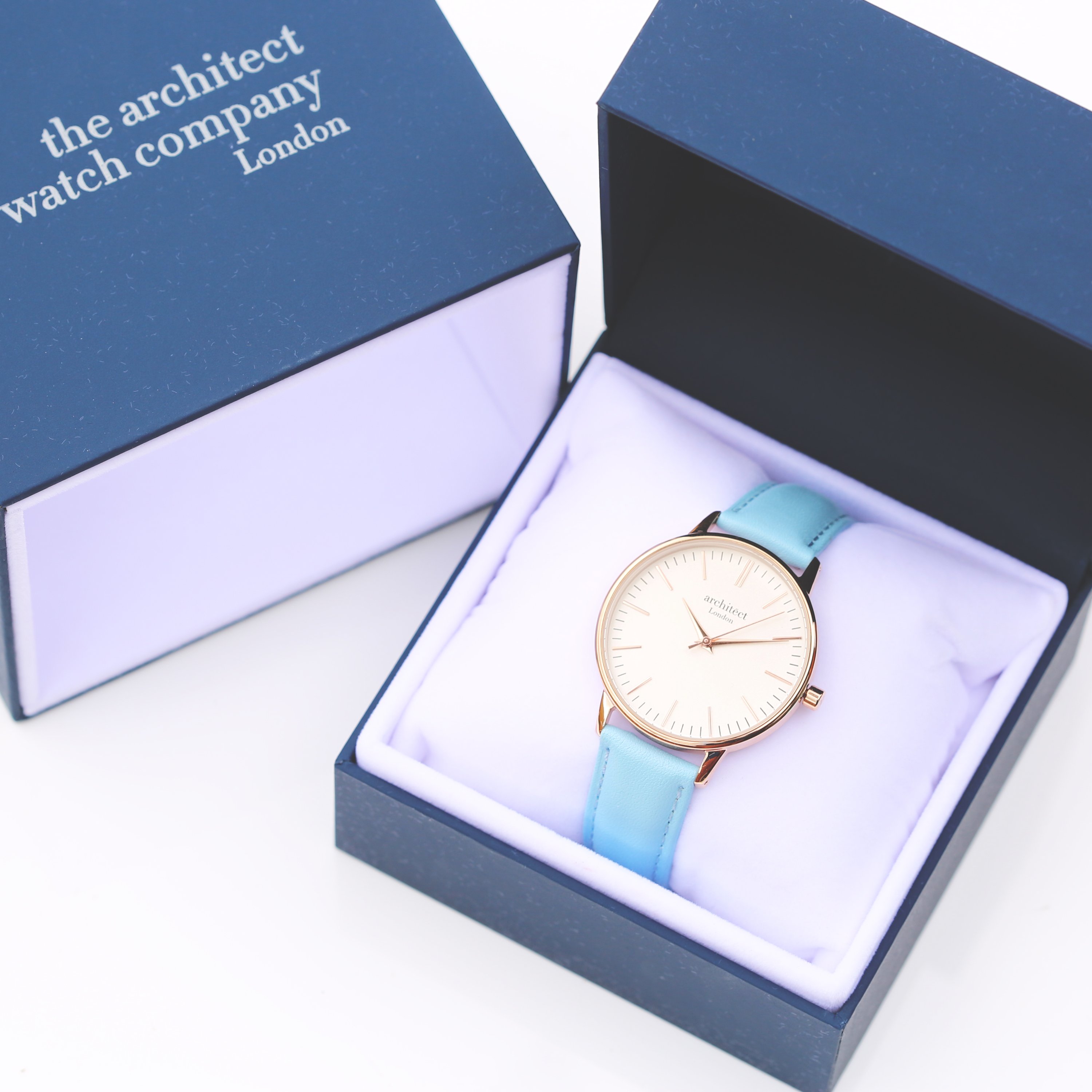 Ladies Architēct Blanc watch featuring a light blue genuine leather strap and modern font engraving on the back.