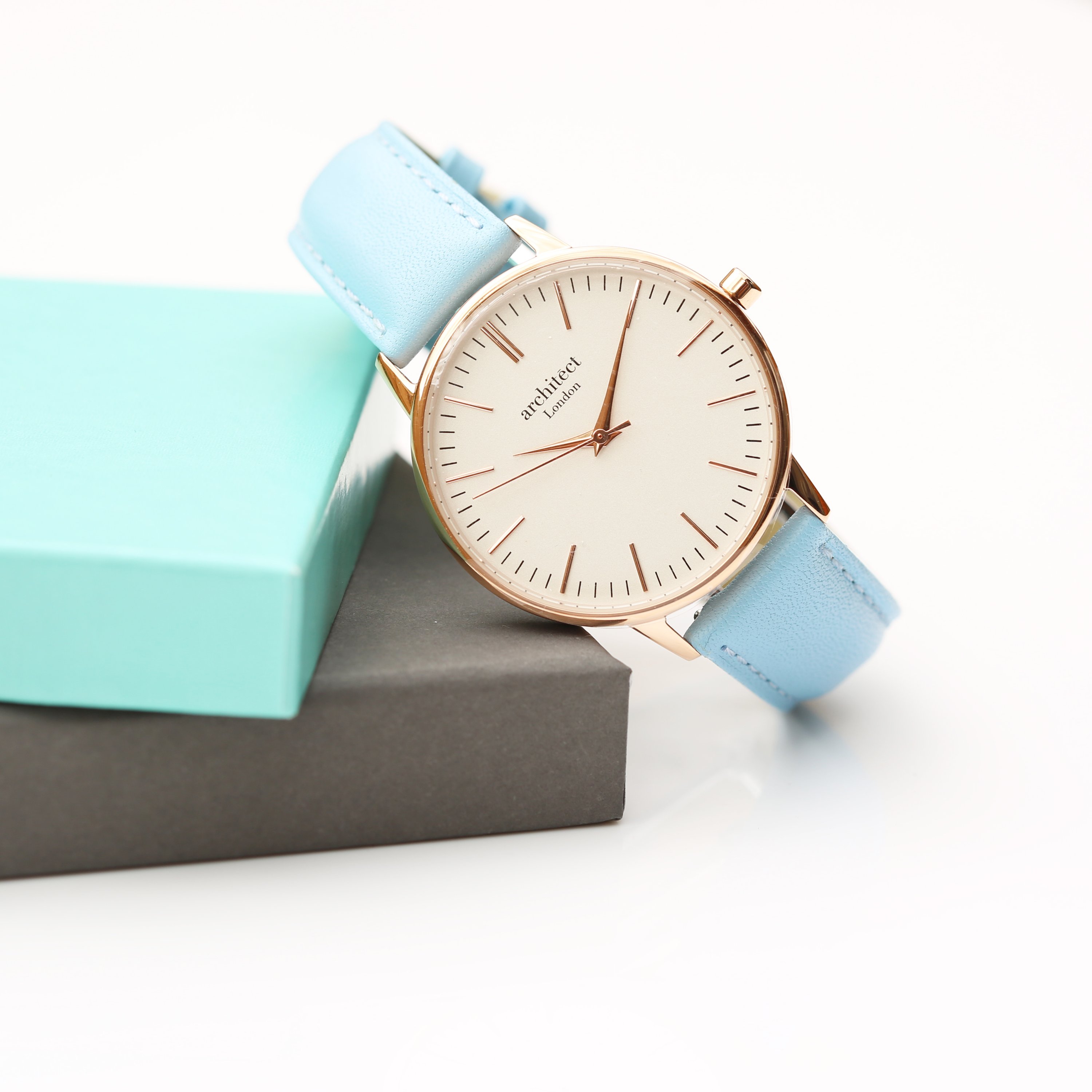 Ladies Architēct Blanc watch featuring a light blue genuine leather strap and modern font engraving on the back.