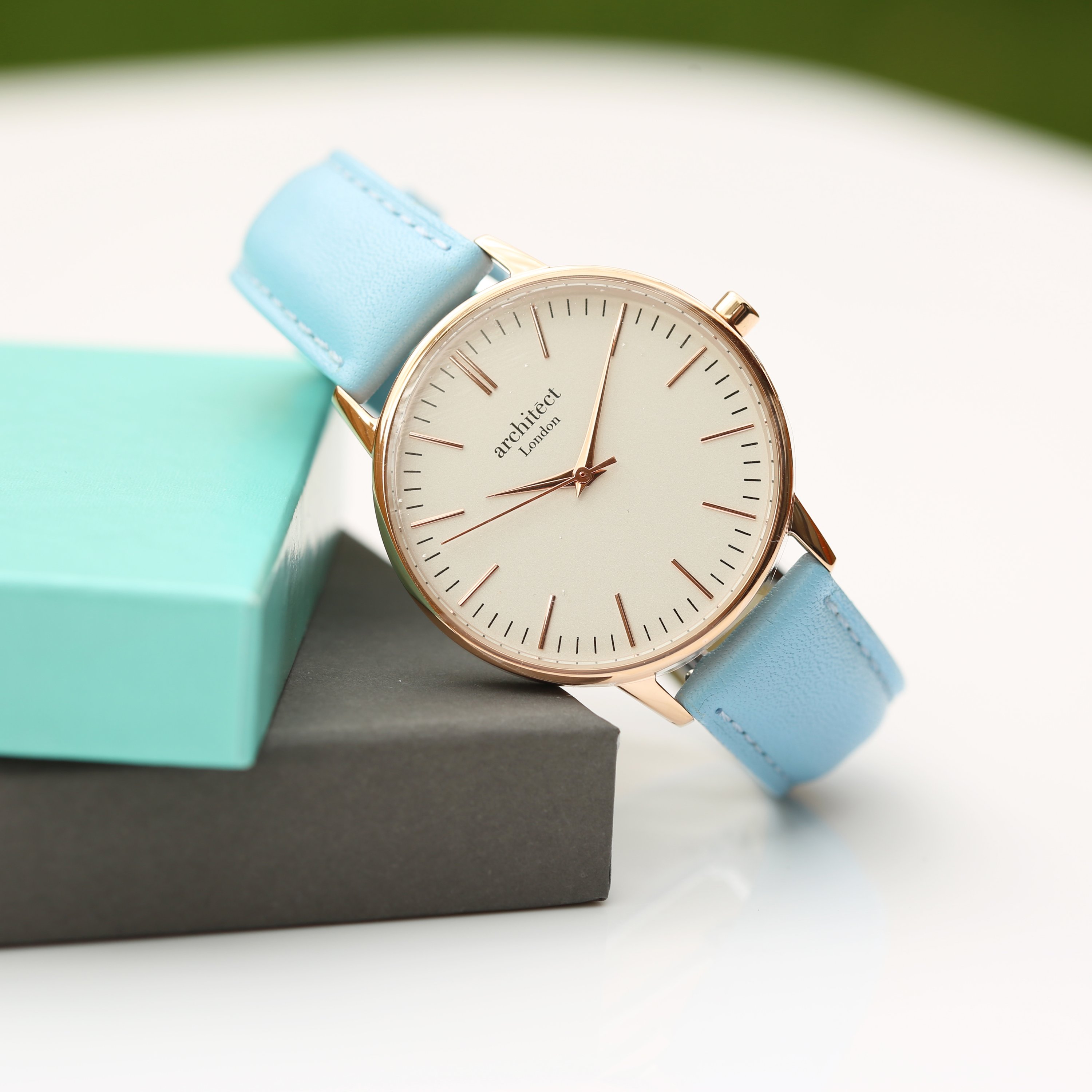 Ladies Architēct Blanc watch featuring a light blue genuine leather strap and modern font engraving on the back.