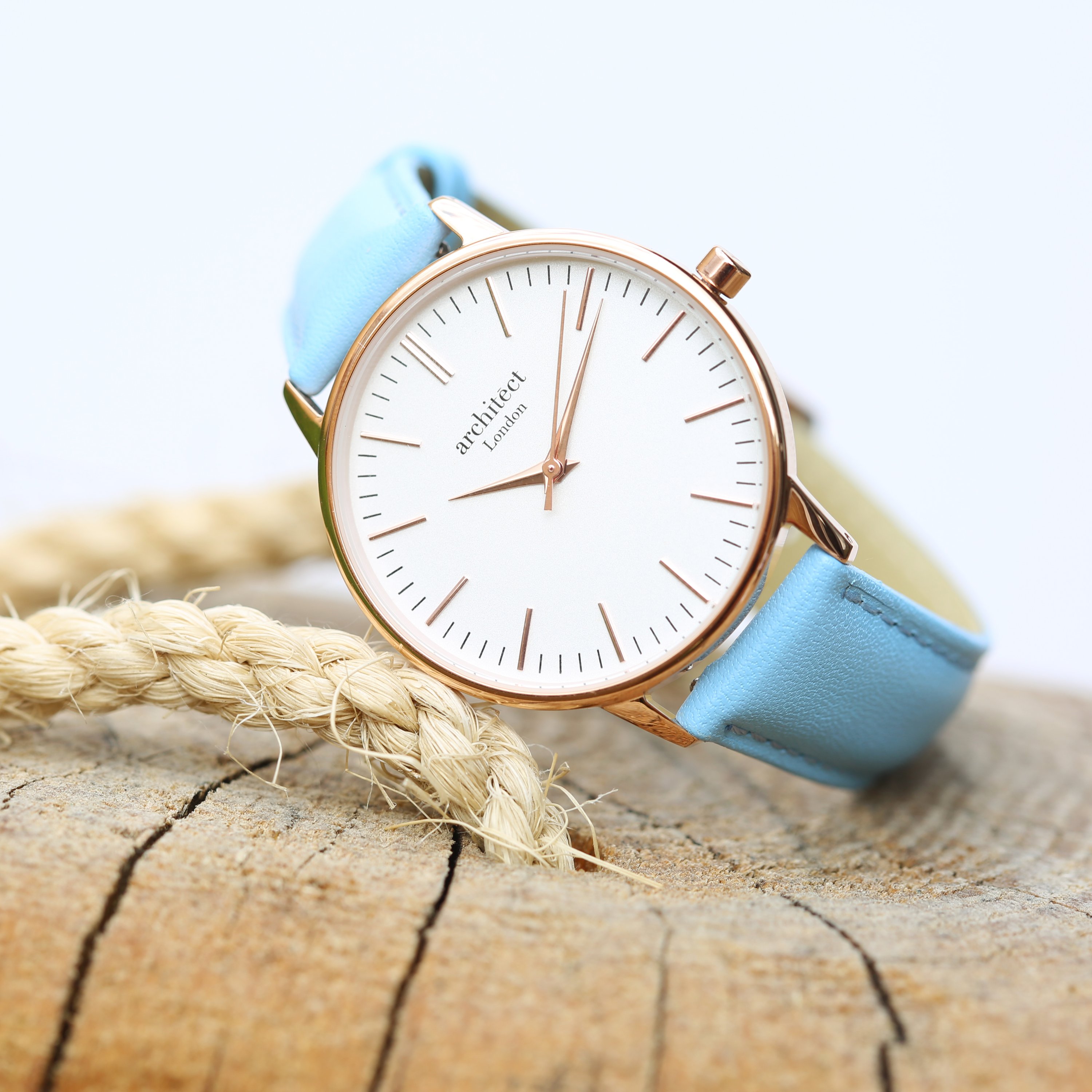 Ladies Architēct Blanc watch featuring a light blue genuine leather strap and modern font engraving on the back.