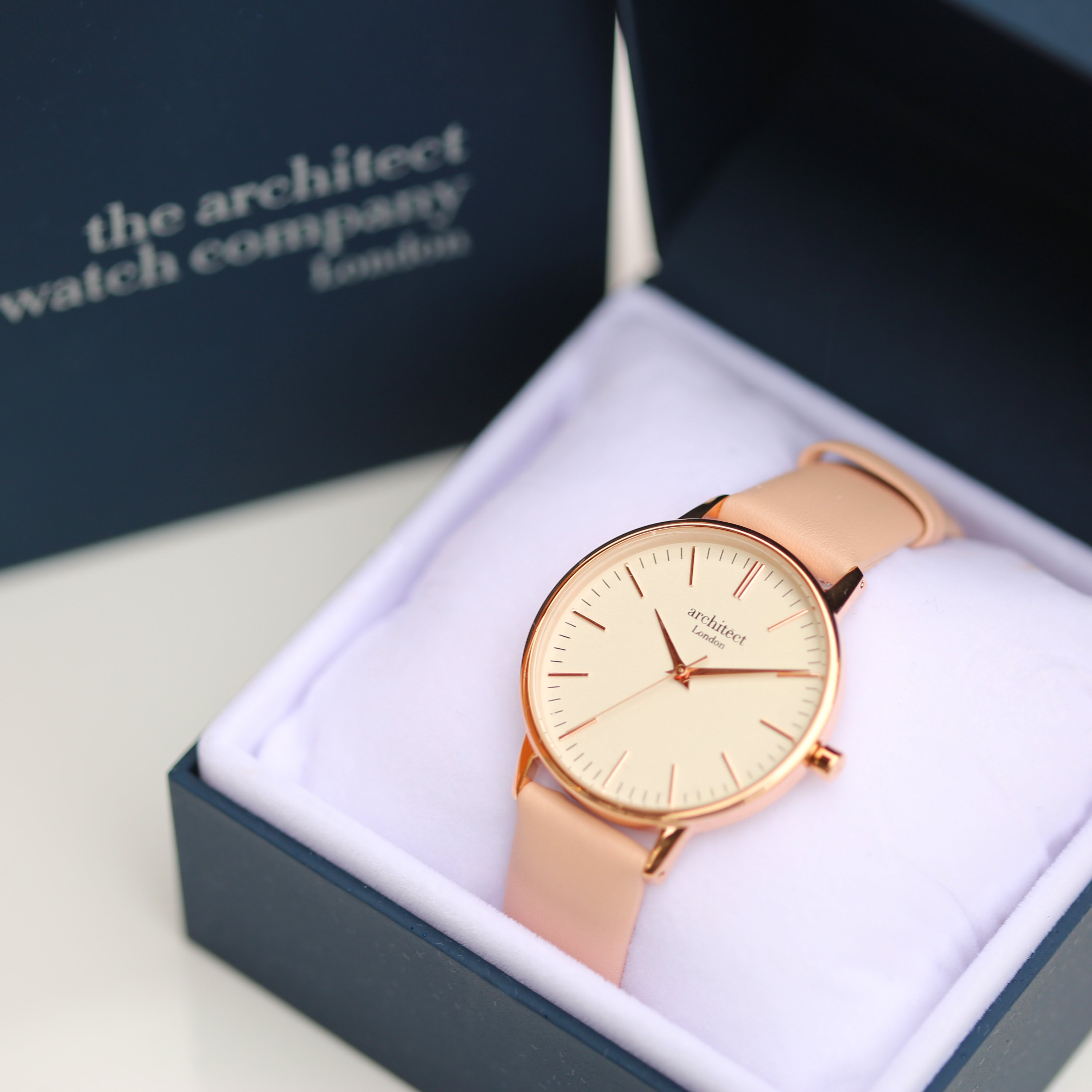 Ladies Architēct Blanc watch featuring a light pink leather strap and modern font engraving on the back, elegantly designed for any occasion.