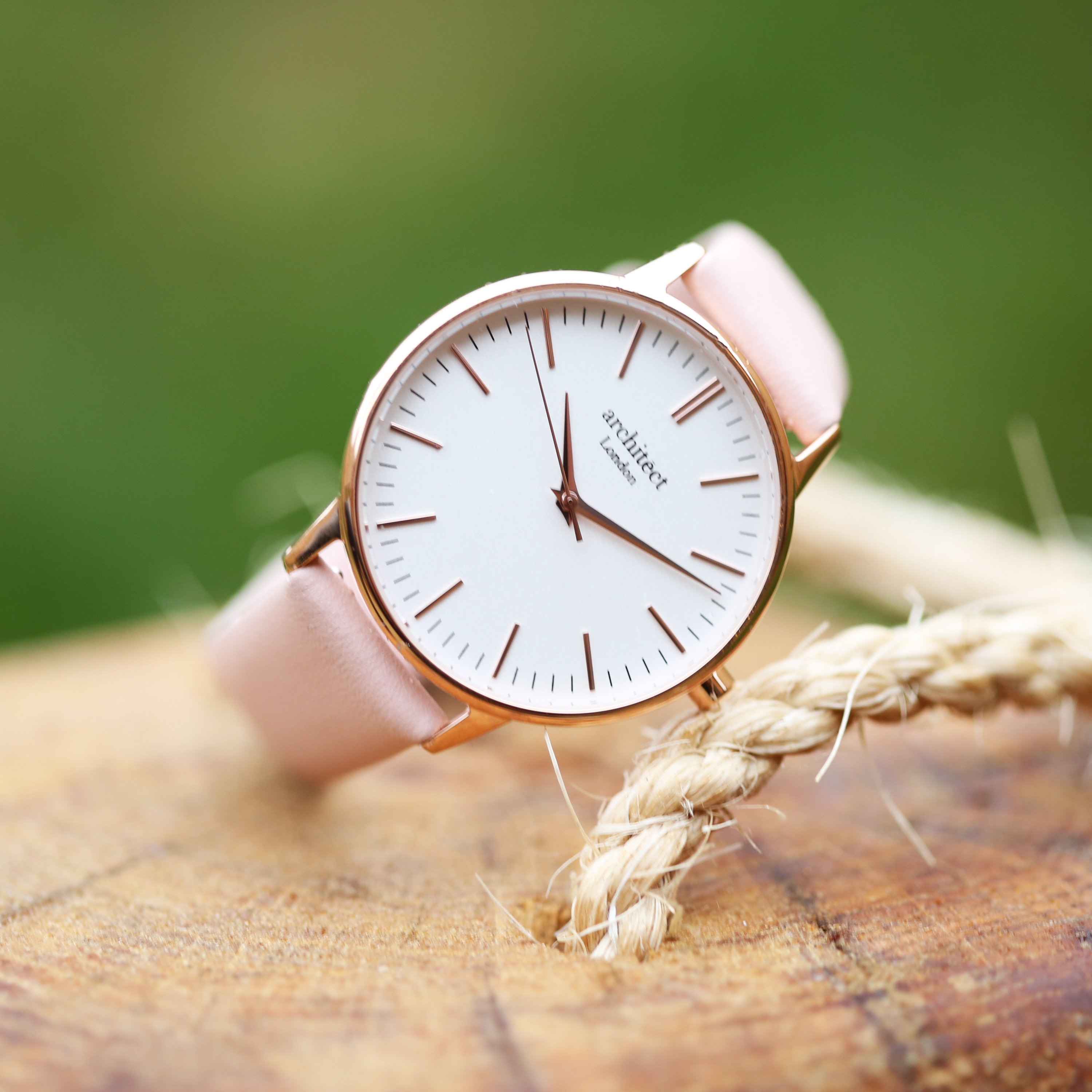 Ladies Architēct Blanc watch featuring a light pink leather strap and modern font engraving on the back, elegantly designed for any occasion.