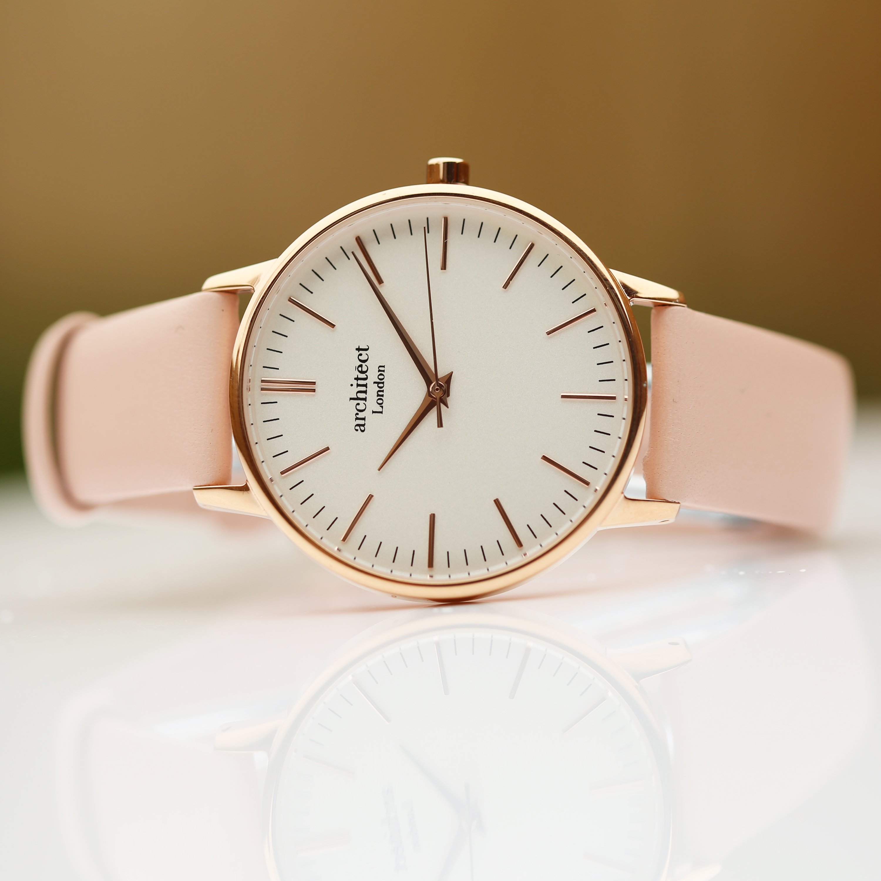 Ladies Architēct Blanc watch featuring a light pink leather strap and modern font engraving on the back, elegantly designed for any occasion.
