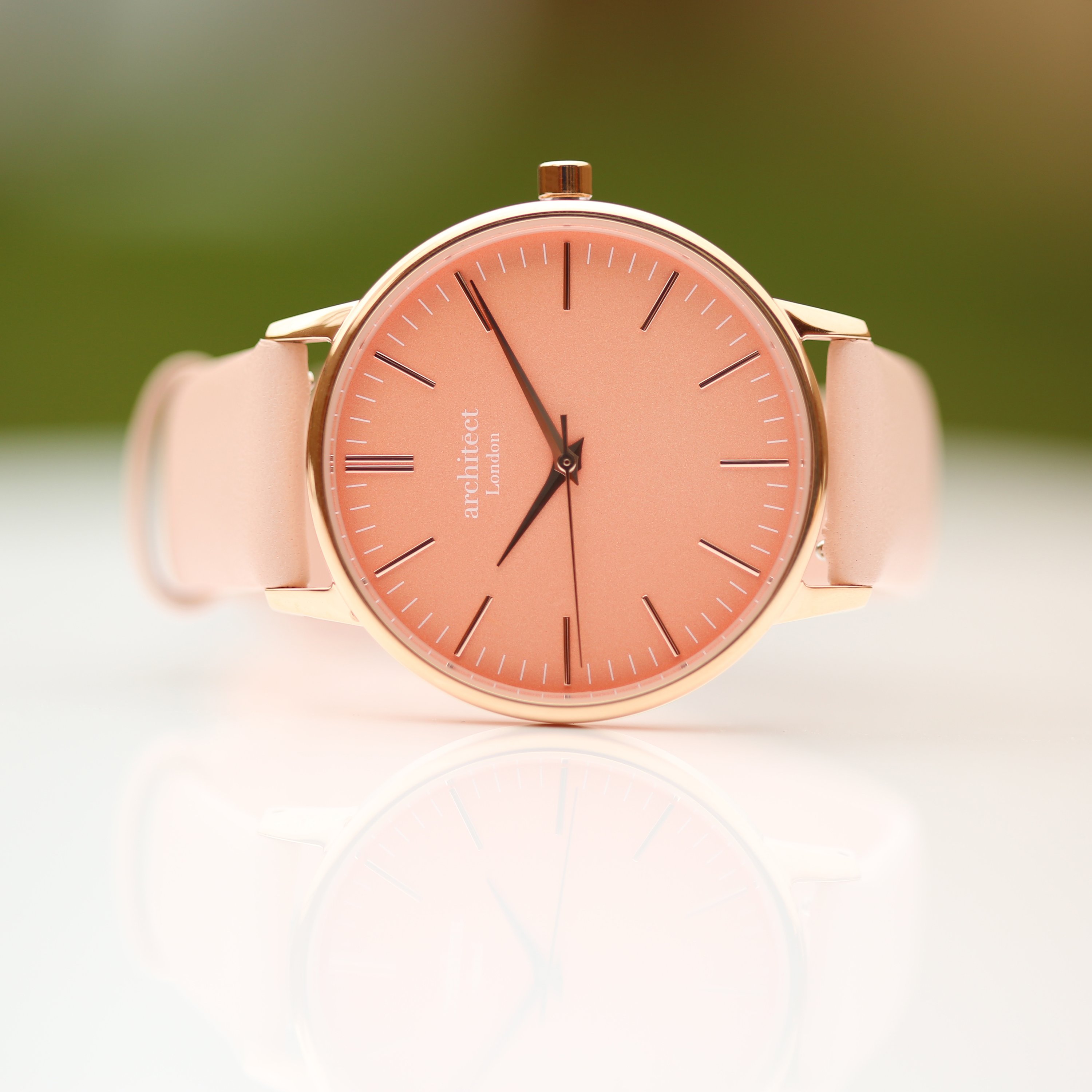 Ladies Architēct Coral watch featuring a light pink leather strap and personalized handwriting engraving on the back.