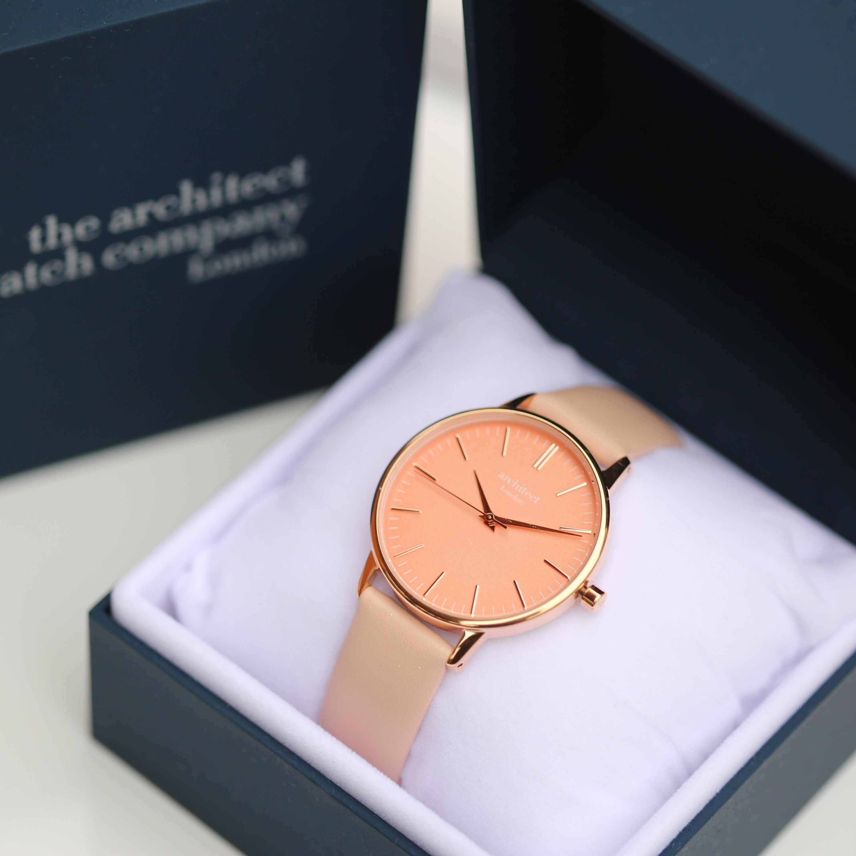 Ladies Architēct Coral watch featuring a light pink leather strap and personalized handwriting engraving on the back.