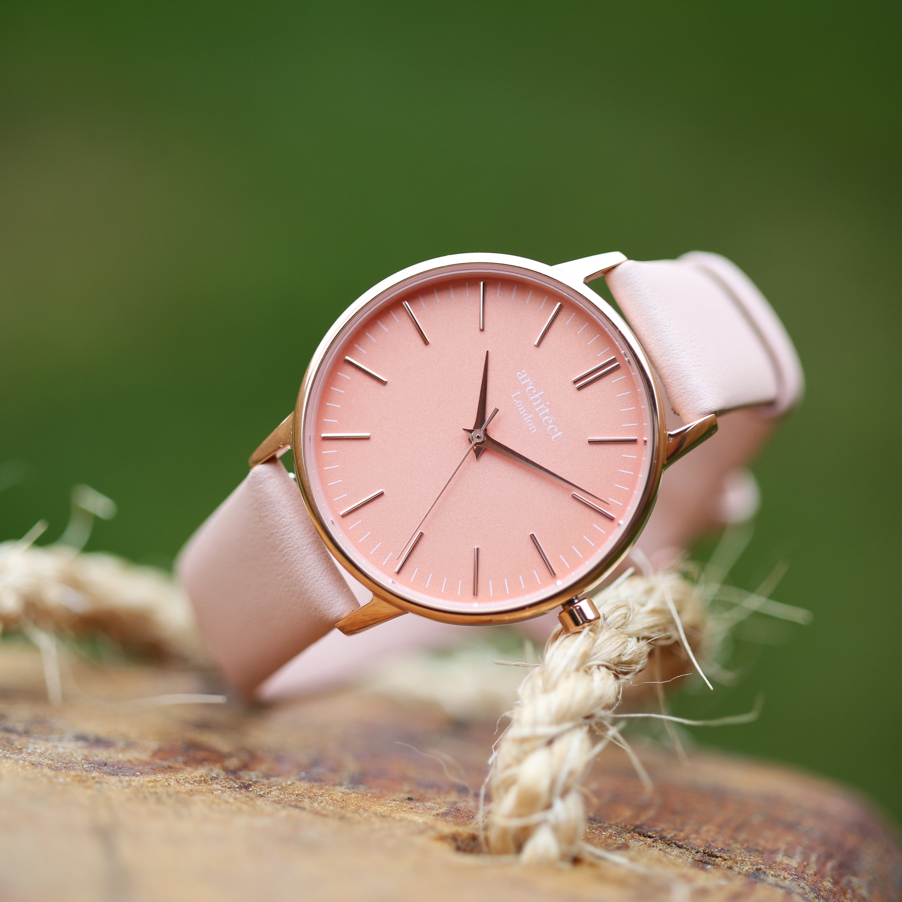 Ladies Architēct Coral watch featuring a light pink leather strap and personalized handwriting engraving on the back.