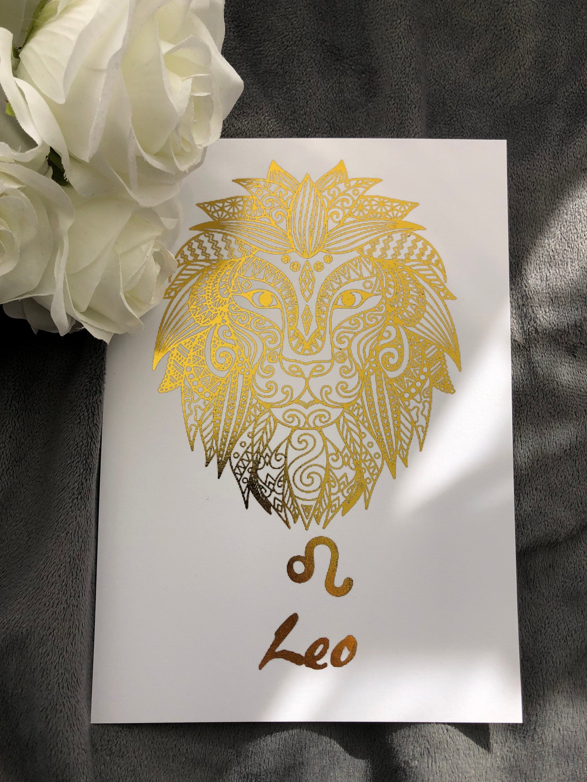 A beautiful Leo Star Sign Foil Print featuring a majestic lion symbol, showcasing vibrant colors and a luxurious foil finish.