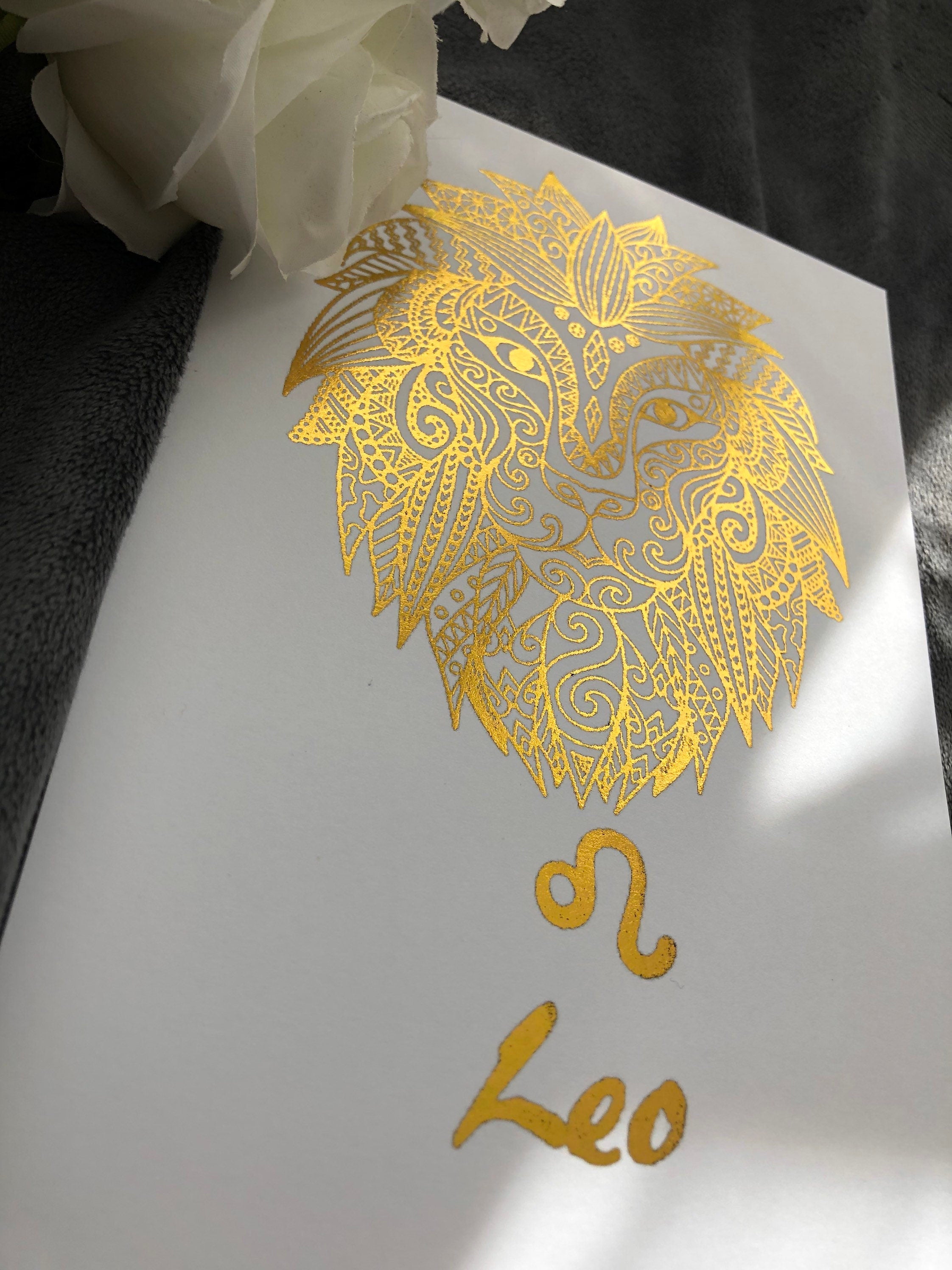 A beautiful Leo Star Sign Foil Print featuring a majestic lion symbol, showcasing vibrant colors and a luxurious foil finish.