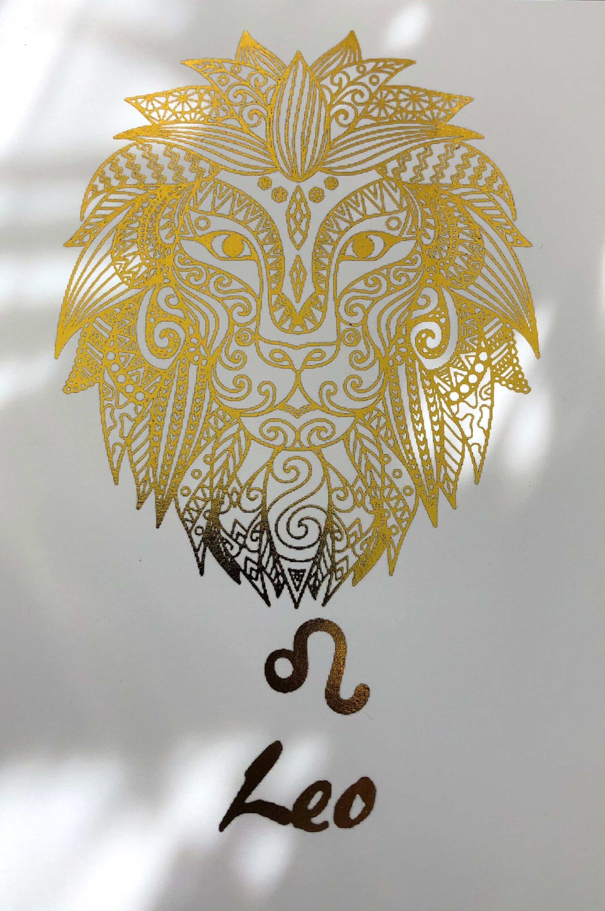 A beautiful Leo Star Sign Foil Print featuring a majestic lion symbol, showcasing vibrant colors and a luxurious foil finish.