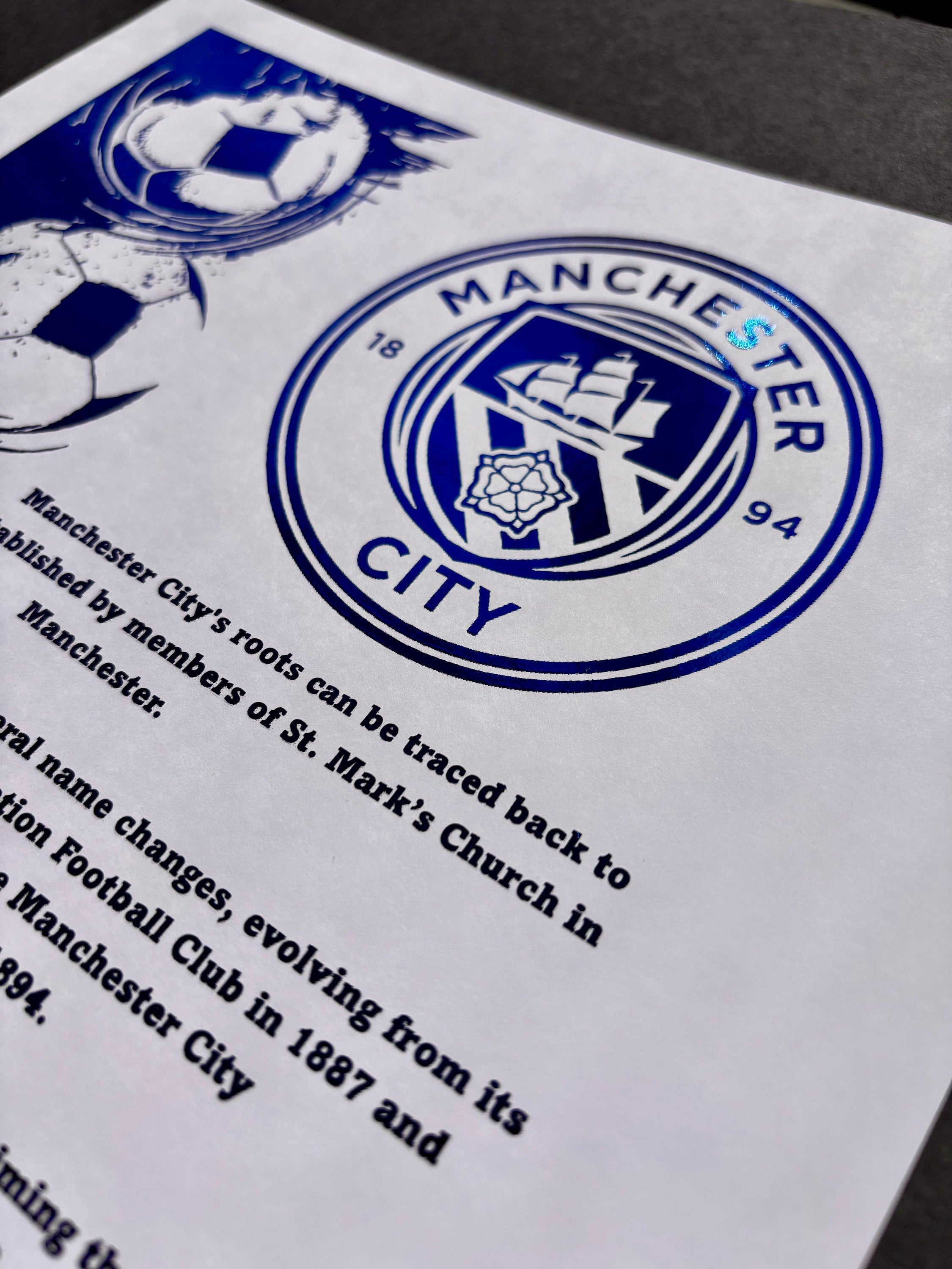 A4 foil print of Manchester City FC logo in radiant blue foil, showcasing the club's rich history and achievements.