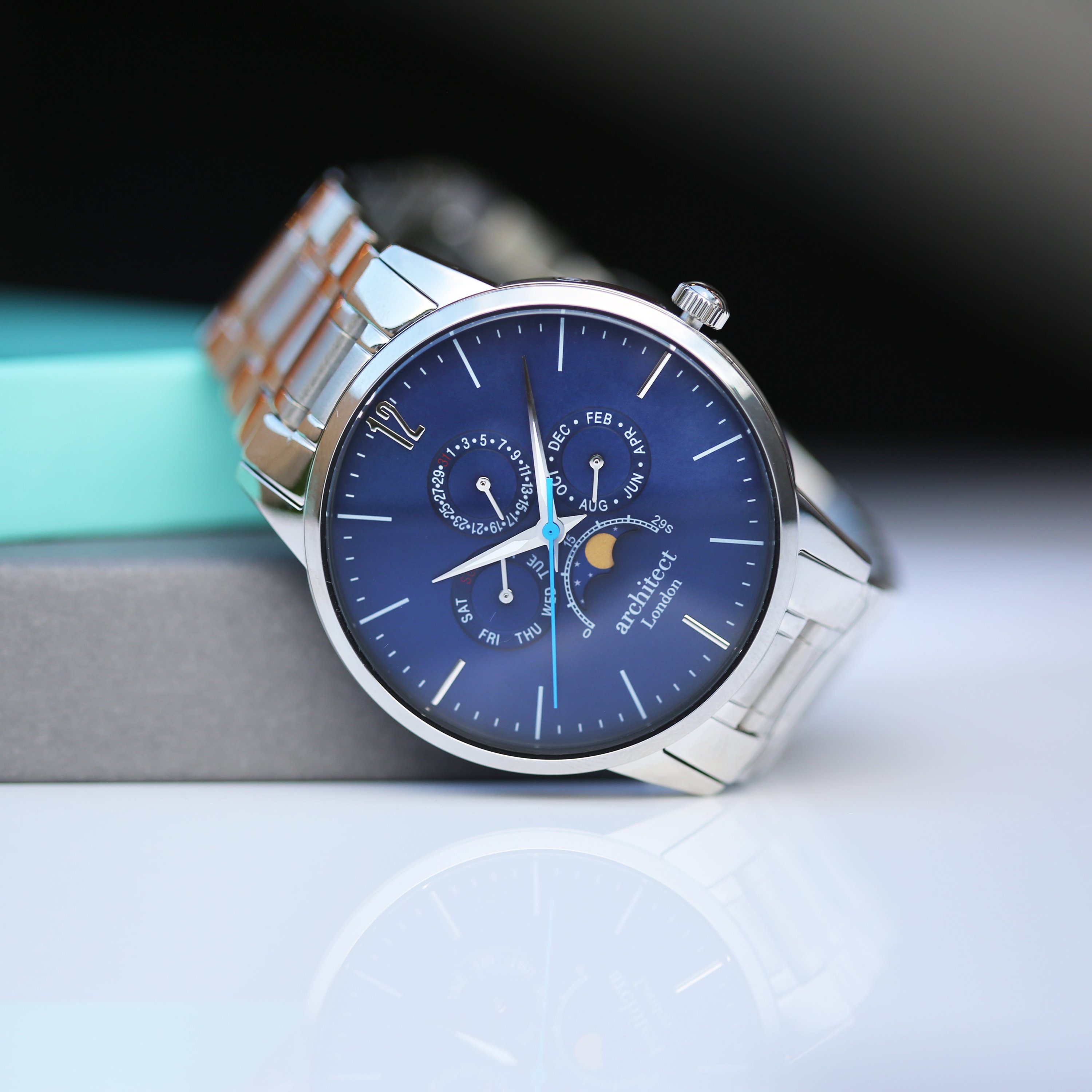 Men's Architect Apollo Blue watch featuring modern font engraving, moonphase display, and chronograph subdials in a polished stainless steel case.