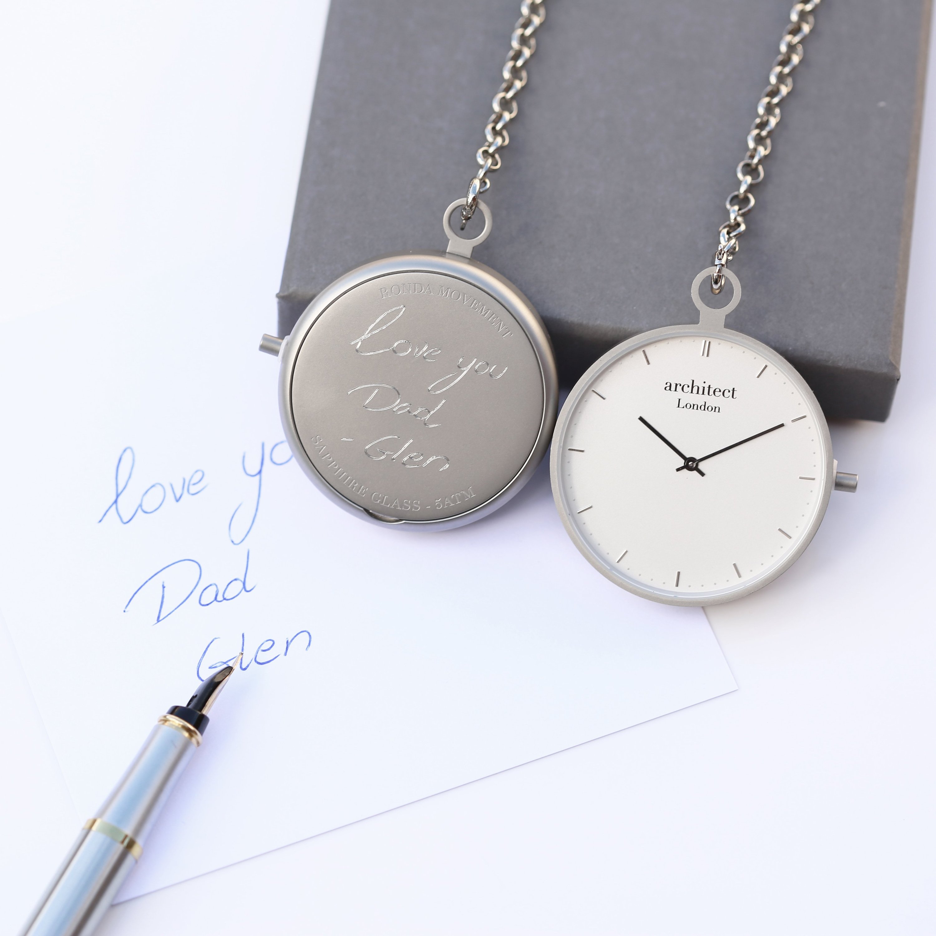 Engraved pocket watch and handwritten note.