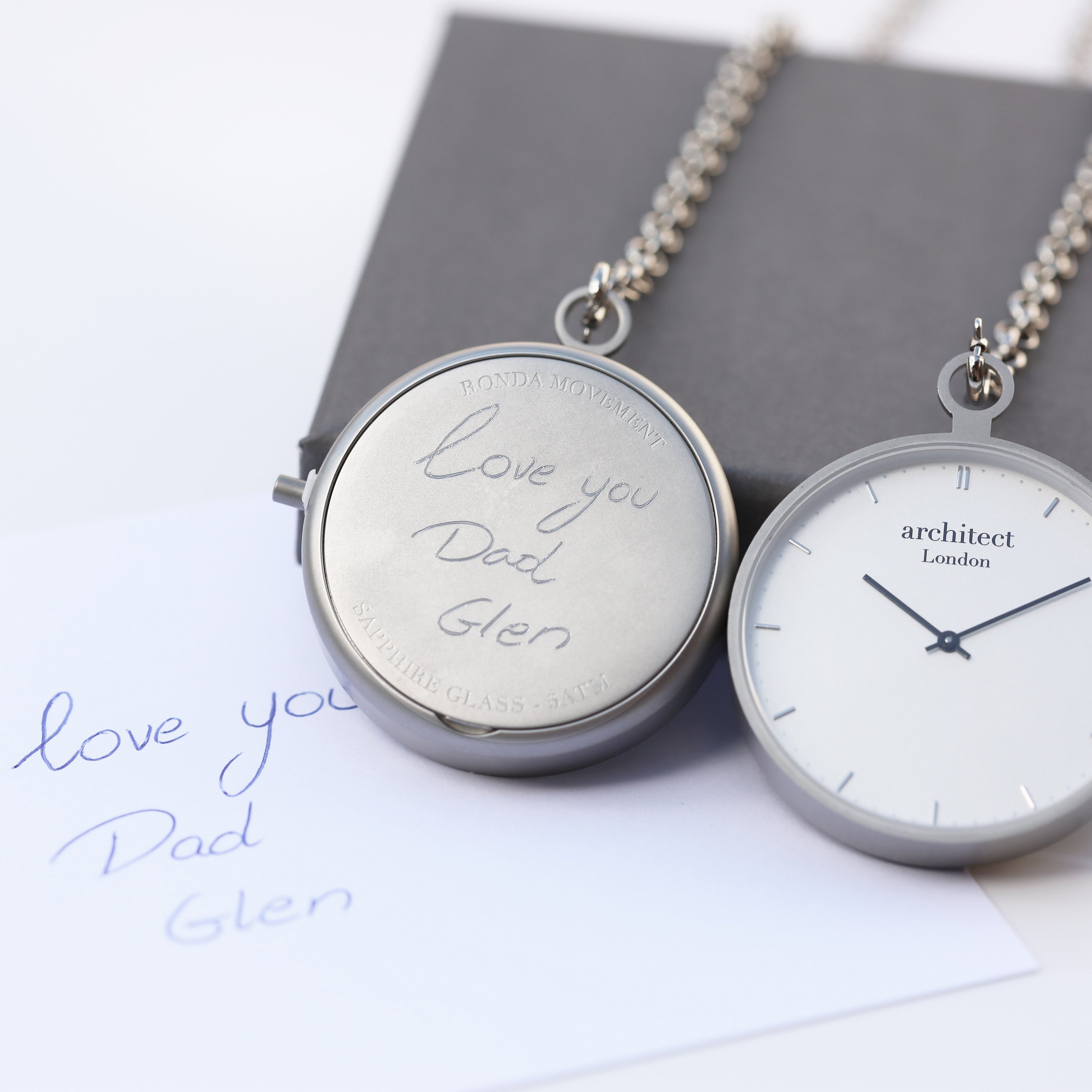 Engraved watch with handwritten note.