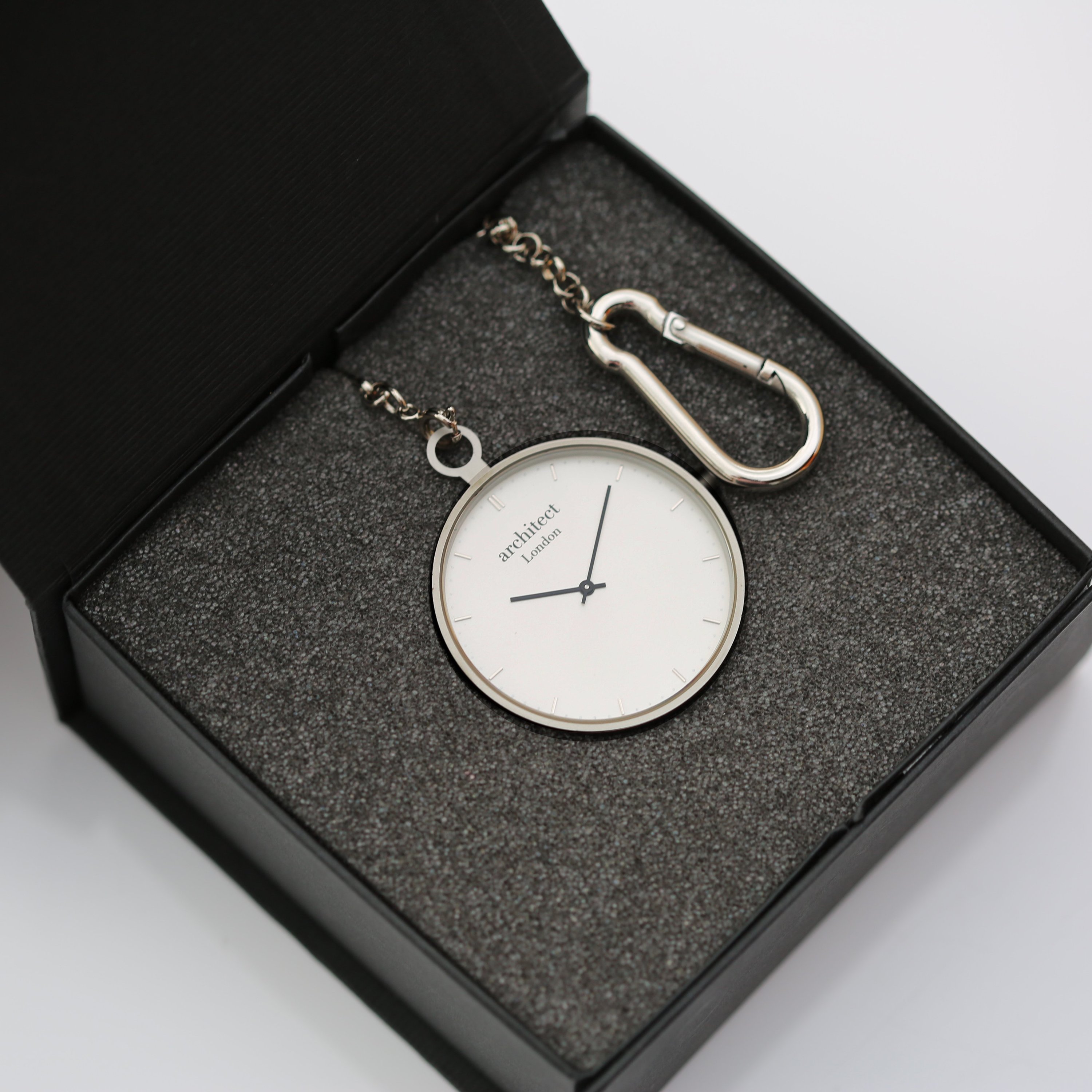 Silver pocket watch in box.