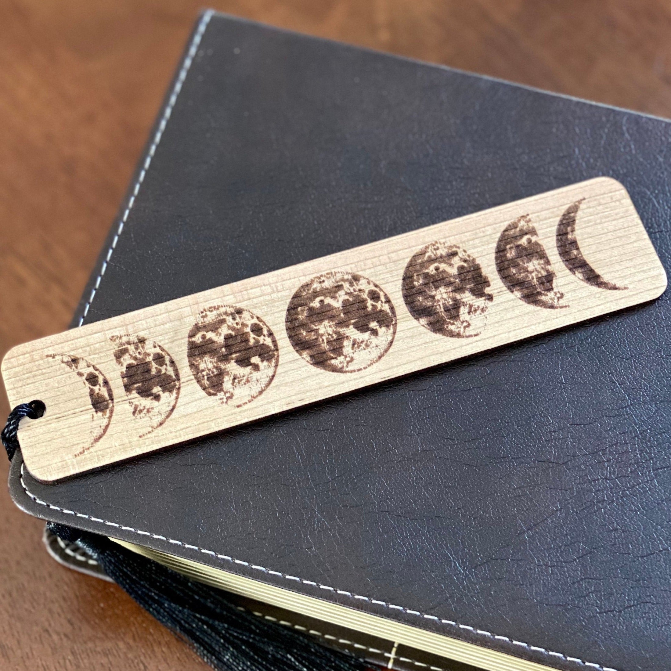 Moon Phases Engraved Wood Bookmark with tassel, showcasing lunar phases design on Cherry hardwood.