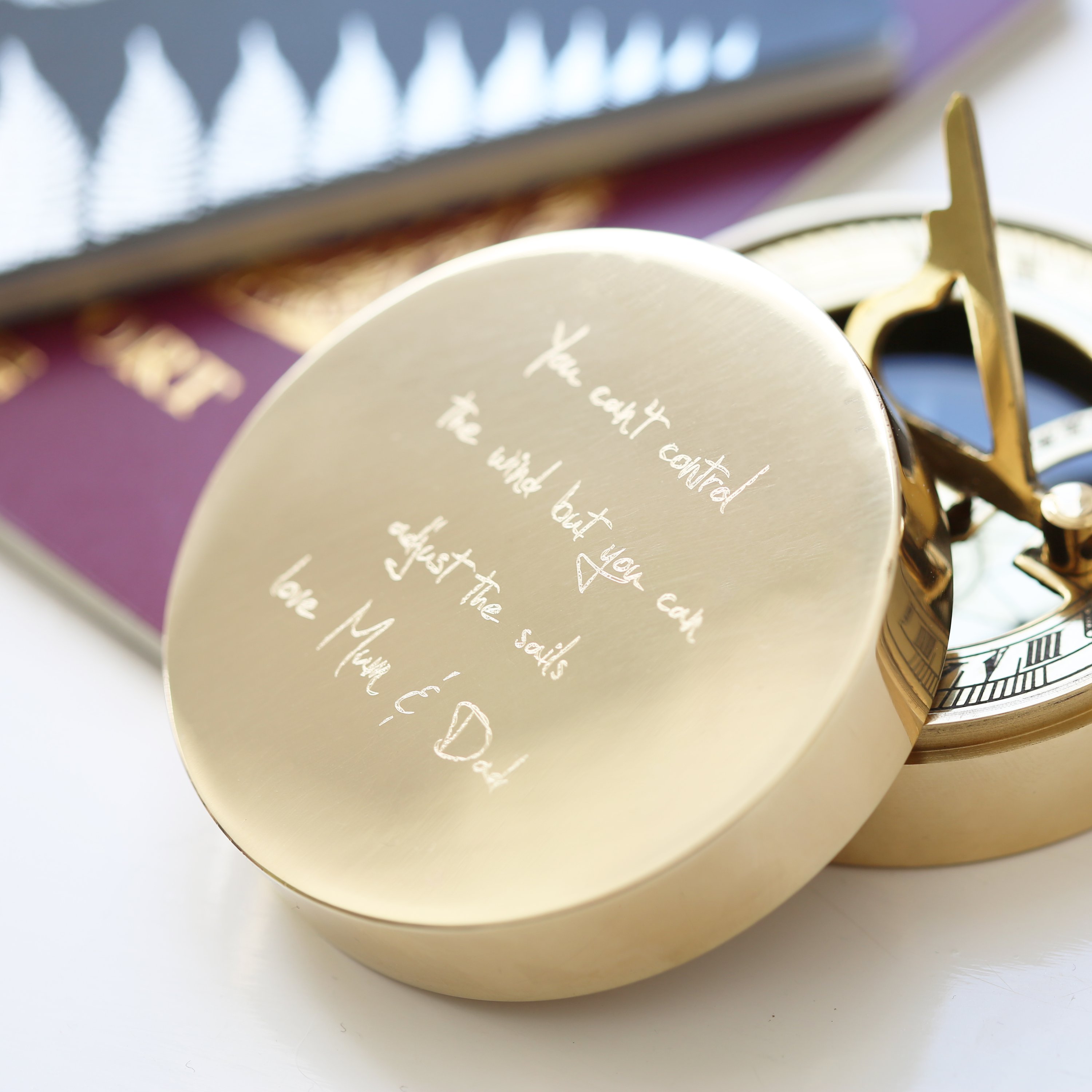 Personalised brass nautical sundial compass with custom handwriting engraving, complete with protective pouch and gift box.