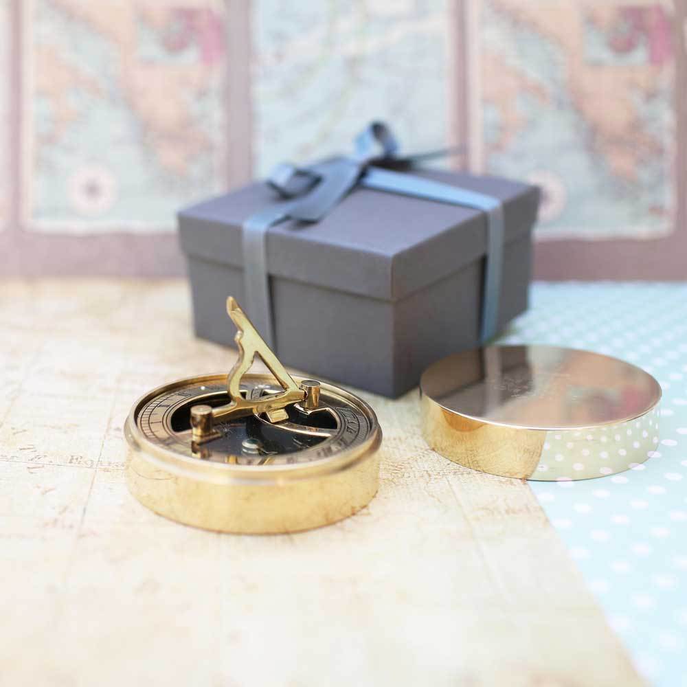 Personalised brass nautical sundial compass with custom handwriting engraving, complete with protective pouch and gift box.