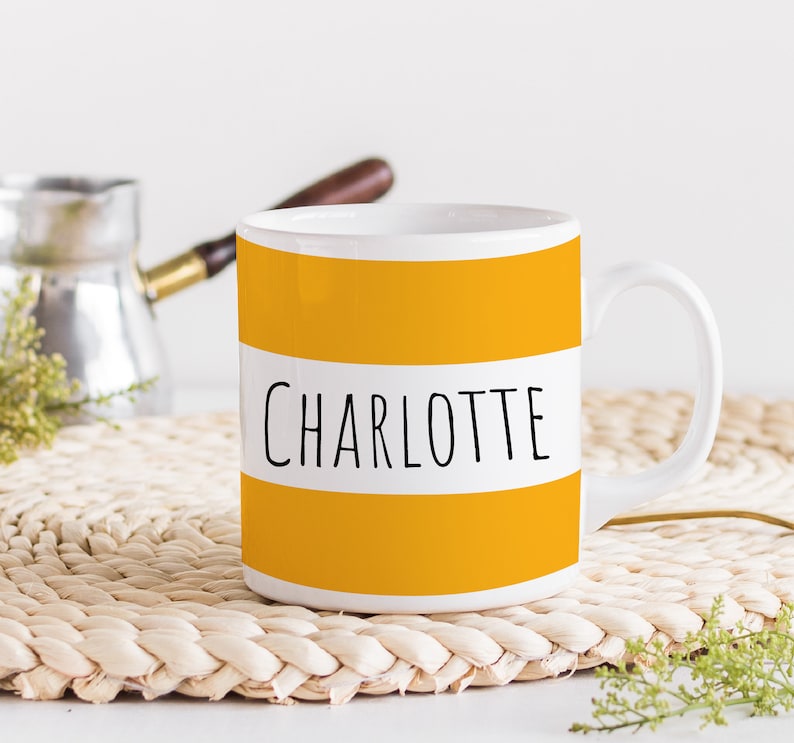 A personalized name mug with colorful borders, perfect for gifts.