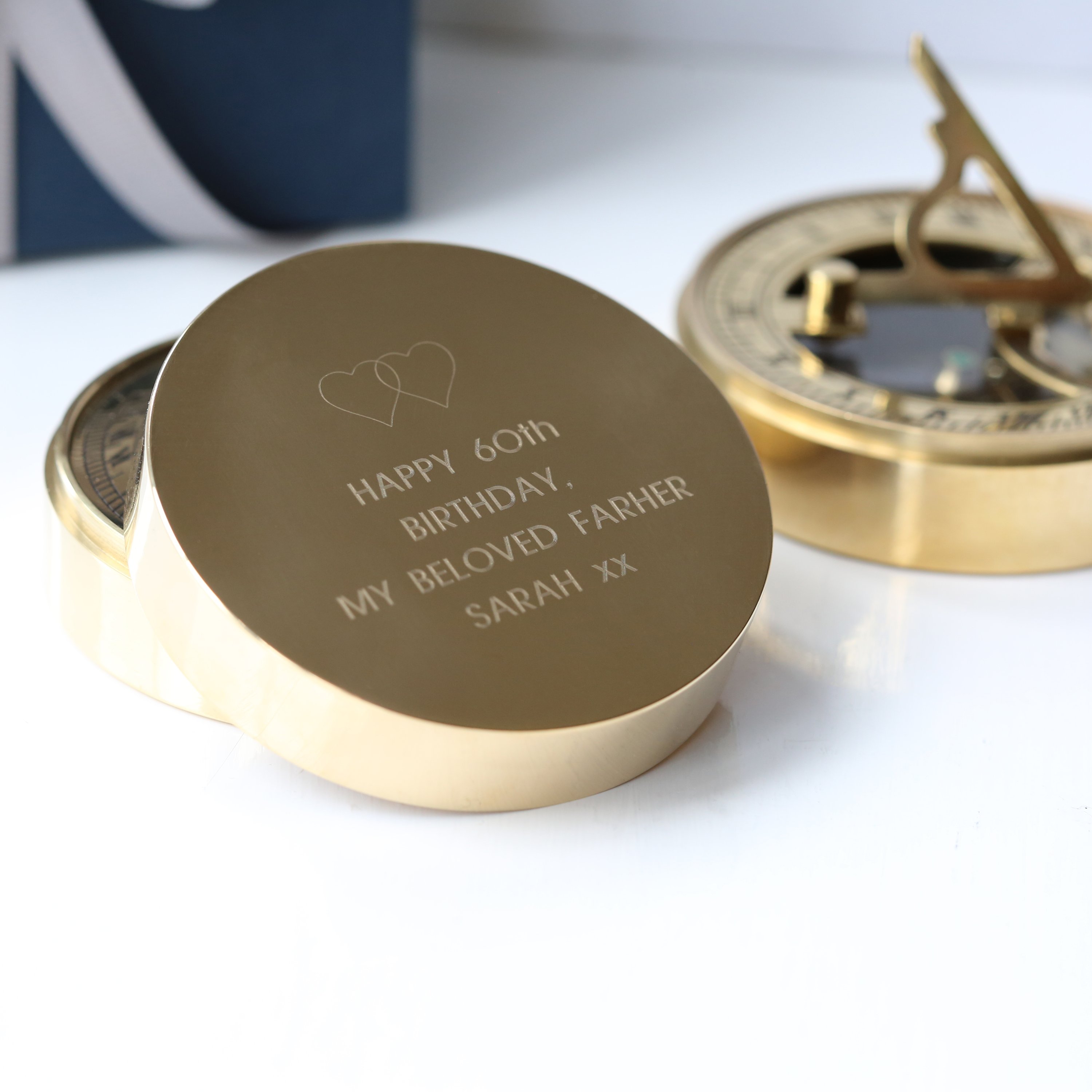A beautifully crafted Personalised Nautical Sundial Compass made of brass, featuring an engraved message and a protective pouch.
