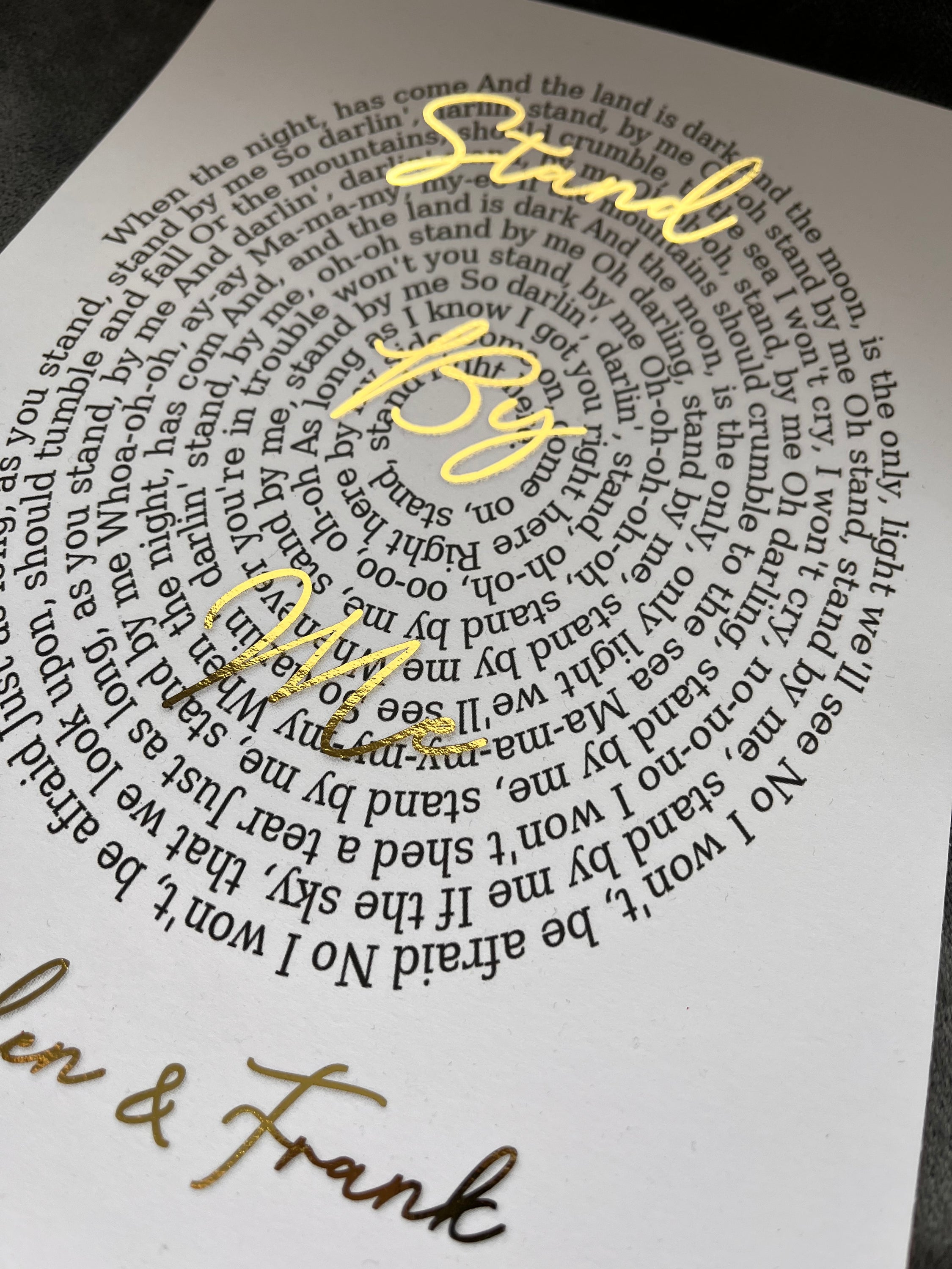 A beautifully designed Spiral Song Lyric Print featuring gold foil lyrics in an elegant spiral layout, personalized with names and song title.