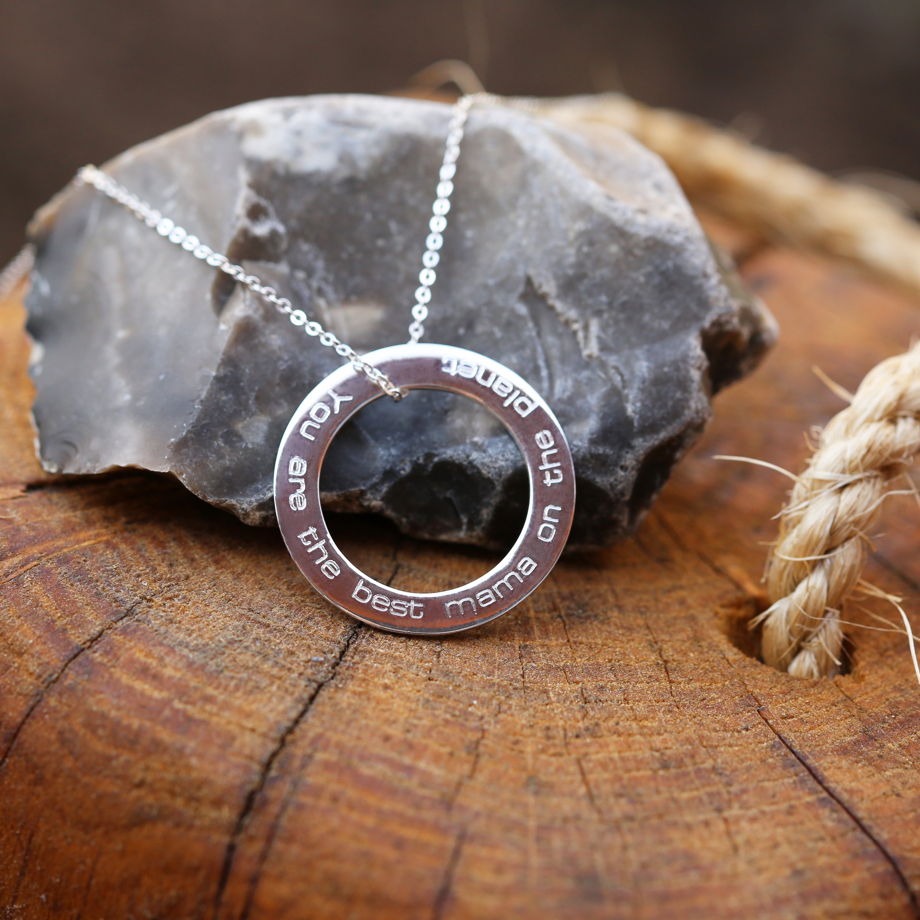 A stunning sterling silver halo necklace with an engraved pendant, elegantly displayed in a gift box.