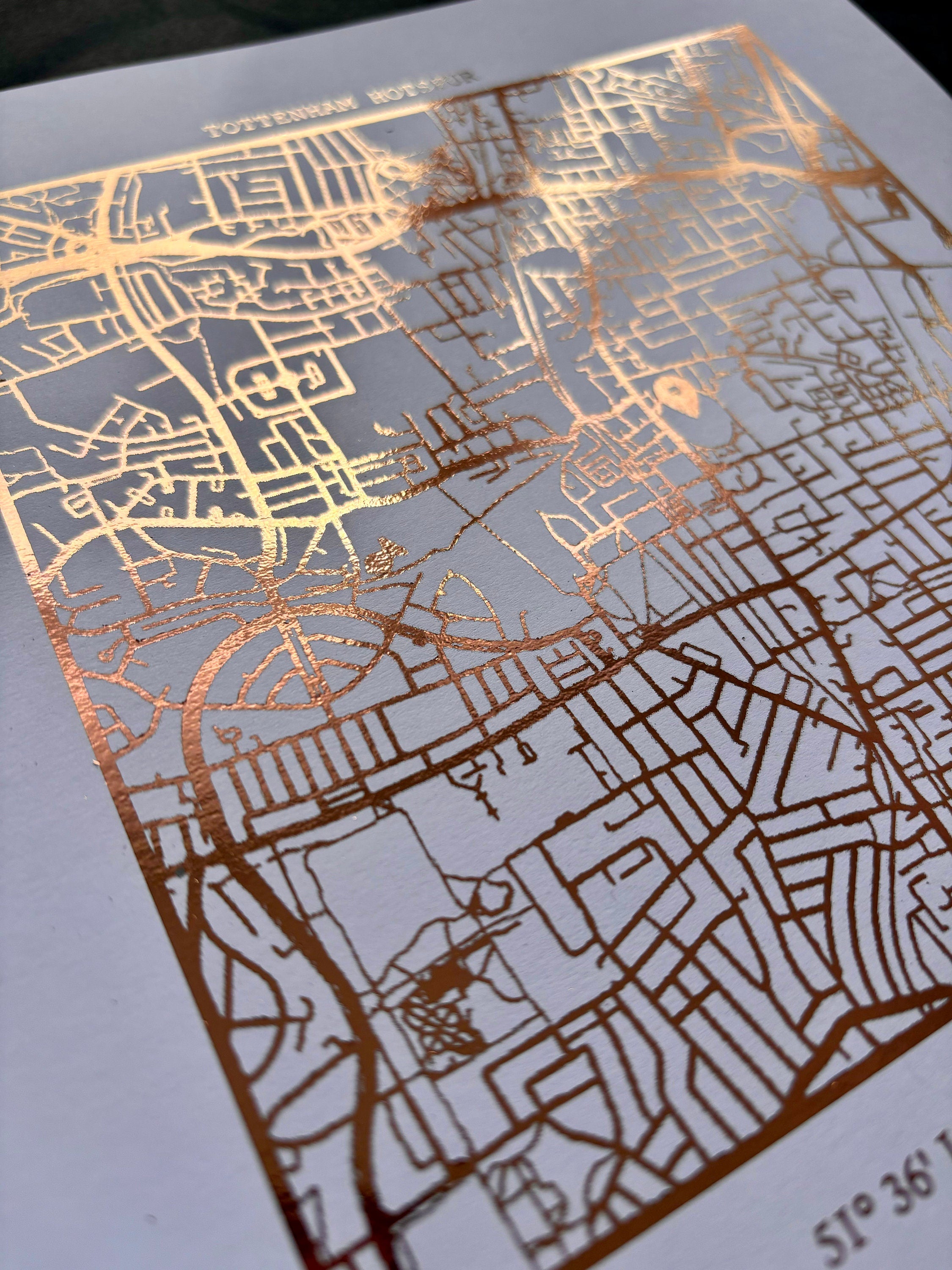 Foil map print of Tottenham Hotspur Stadium featuring intricate detailing and coordinates, perfect for fans.