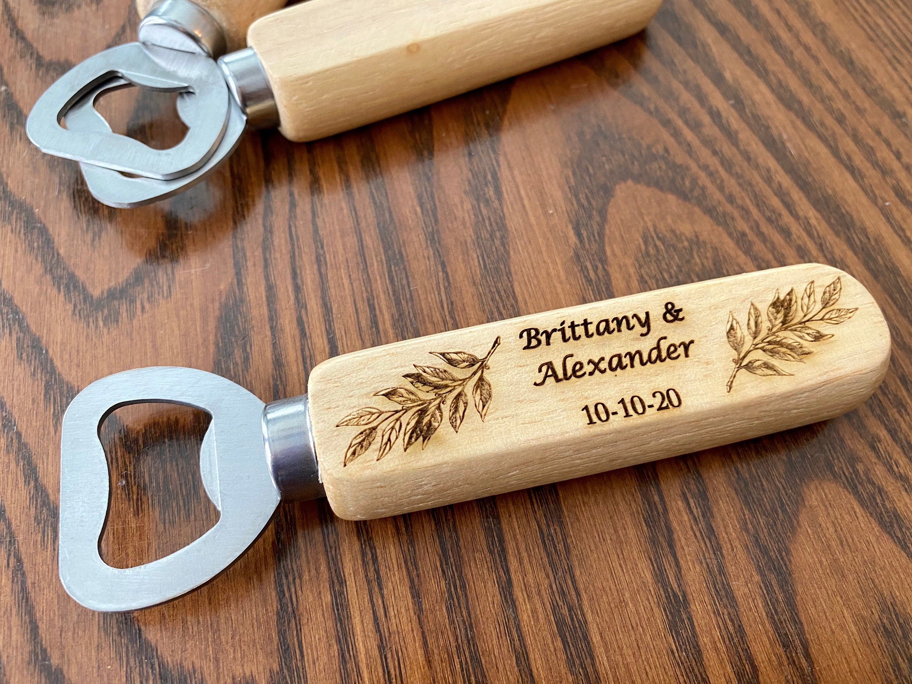 Personalized wooden bottle opener with engraved names and leaf design, perfect for rustic wedding favors.