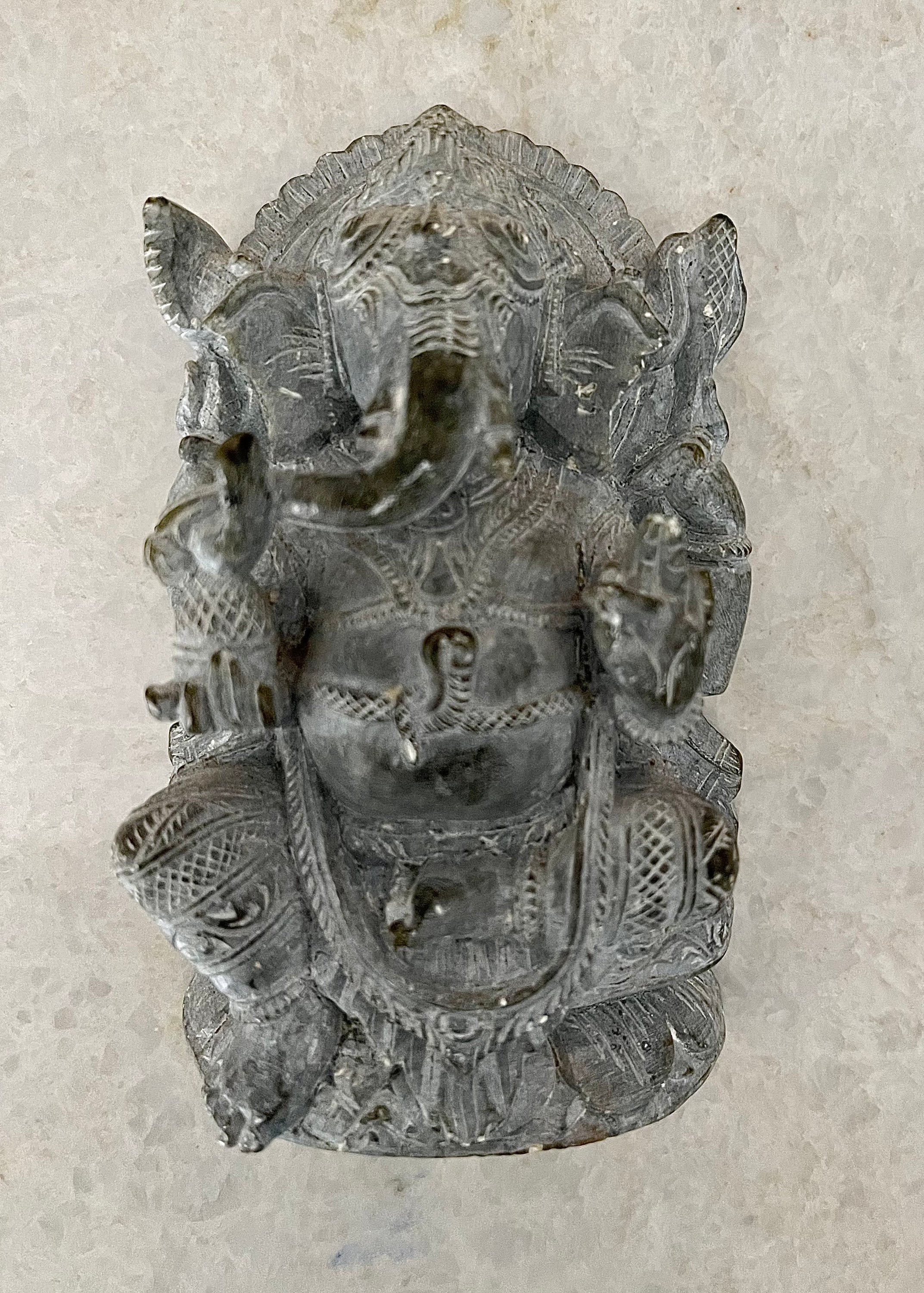 Handcrafted soapstone sculpture of God Ganesha with elephant head, showcasing intricate details and a serene expression, symbolizing wisdom and good fortune.
