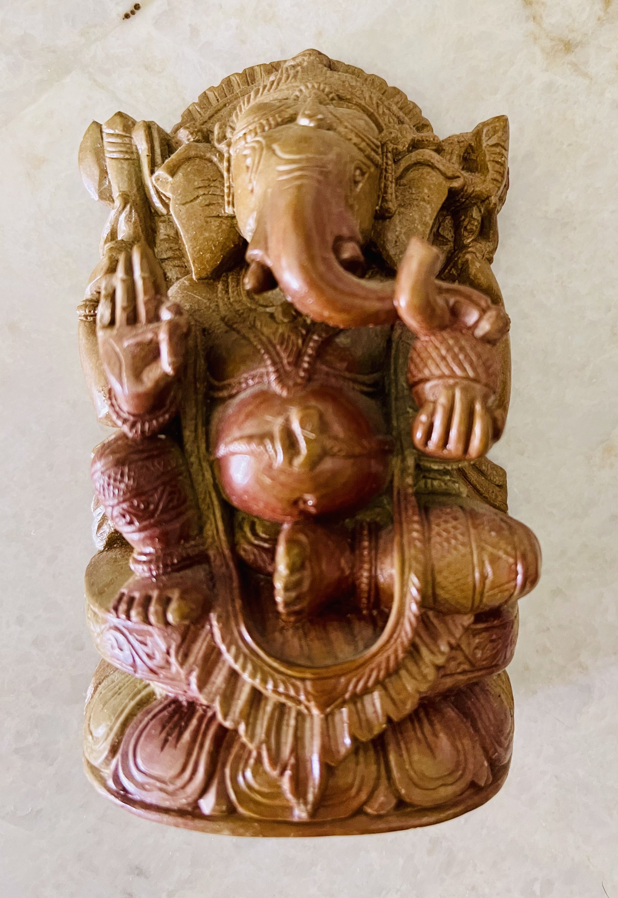 Handcrafted soapstone sculpture of God Ganesha with elephant head, showcasing intricate details and a serene expression, symbolizing wisdom and good fortune.