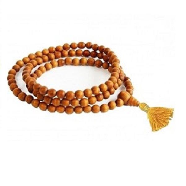 Handmade Sandalwood Mala featuring 108 round beads, knotted for japa meditation, with a sumeru bead and cotton string, presented in a protective transparent bag.