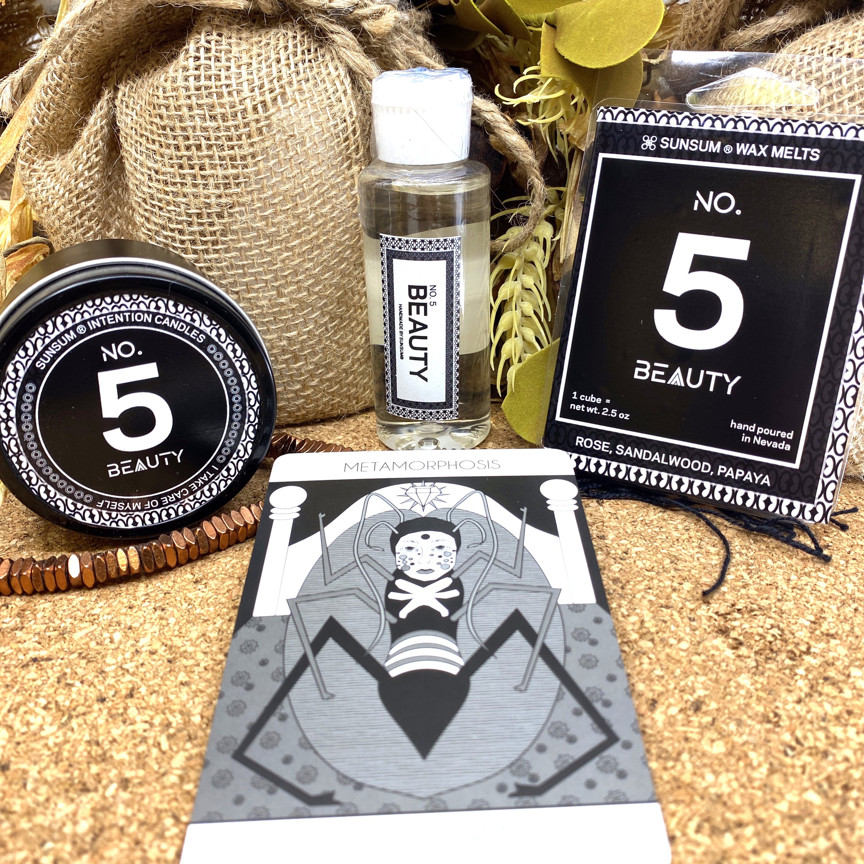 Spirit Number 555 Gift Set featuring handmade products including candles, body oils, and wax melts with floral and fruity aromas.