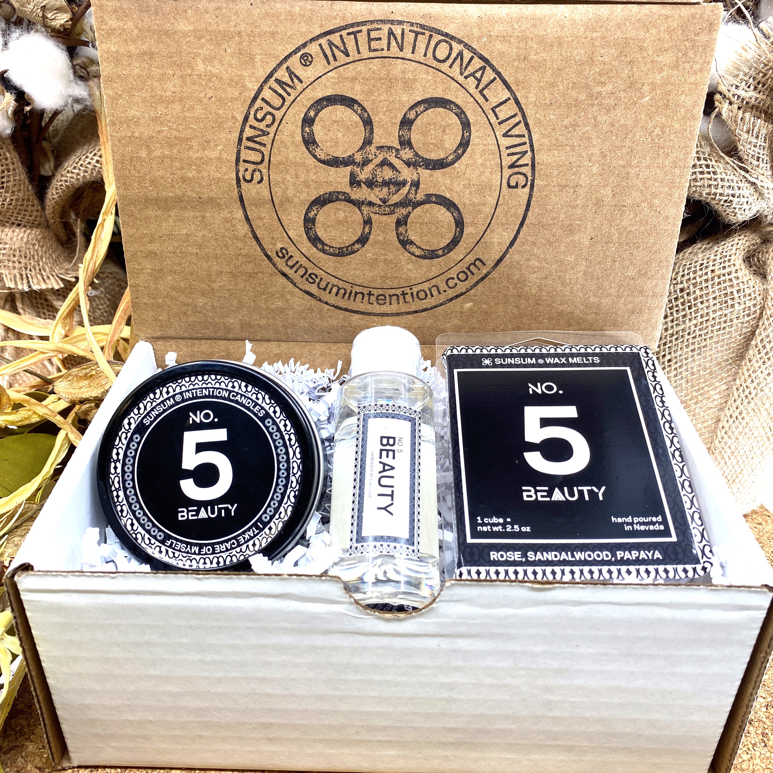 Spirit Number 555 Gift Set featuring handmade products including candles, body oils, and wax melts with floral and fruity aromas.