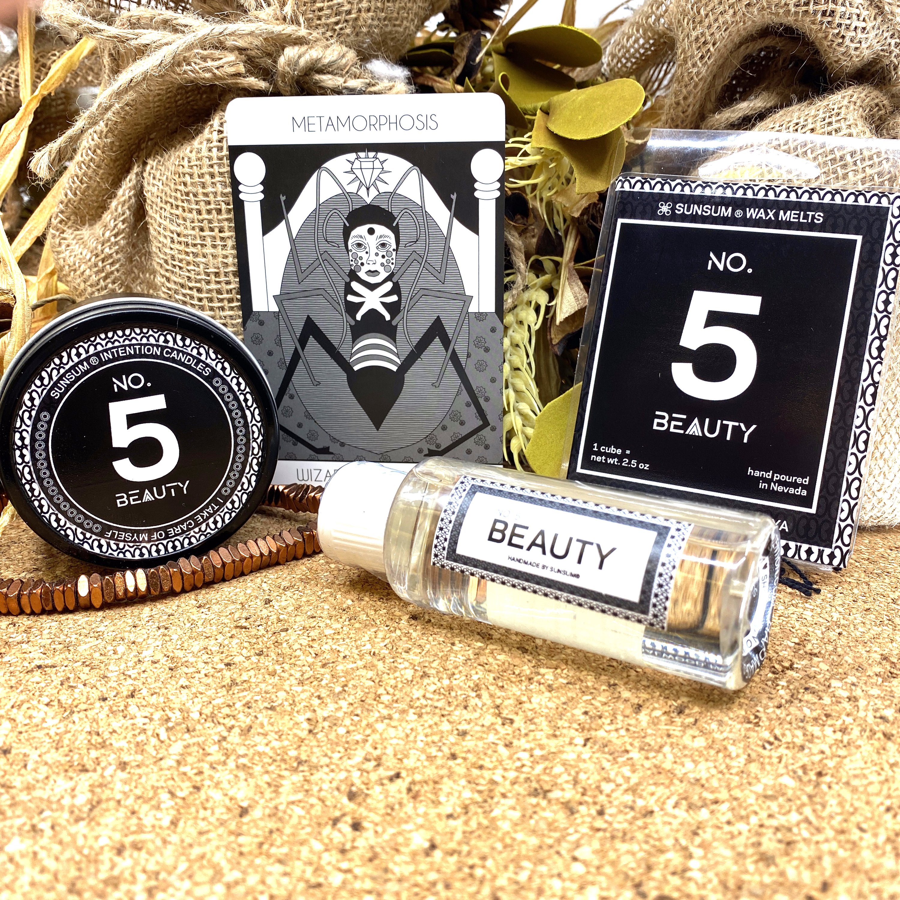 Spirit Number 555 Gift Set featuring handmade products including candles, body oils, and wax melts with floral and fruity aromas.