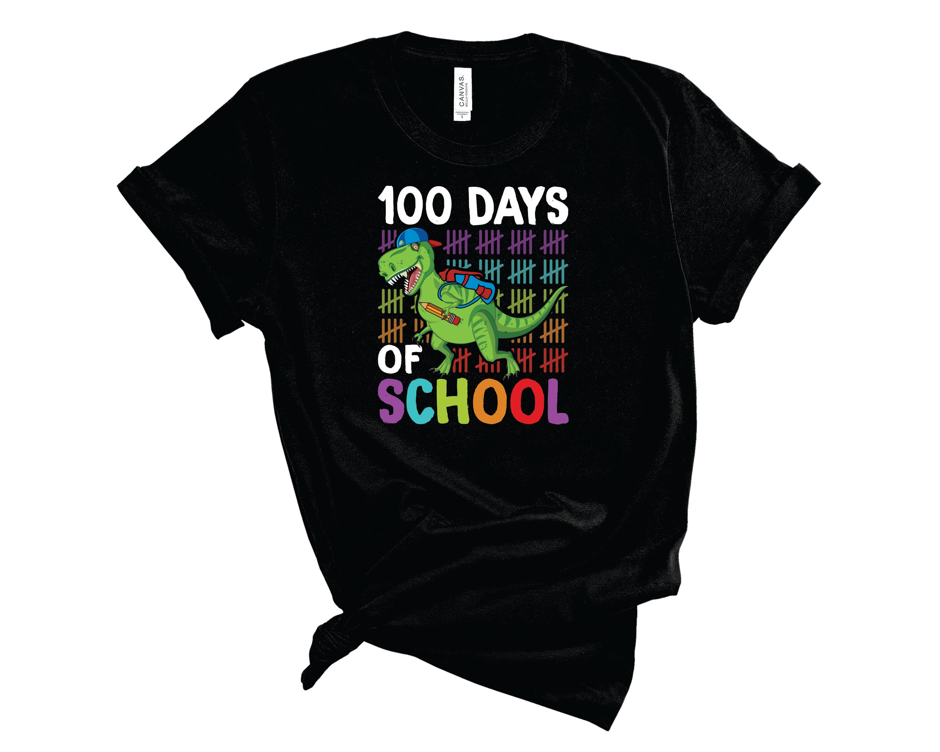 A colorful unisex t-shirt featuring a playful dinosaur graphic, celebrating 100 days of school.
