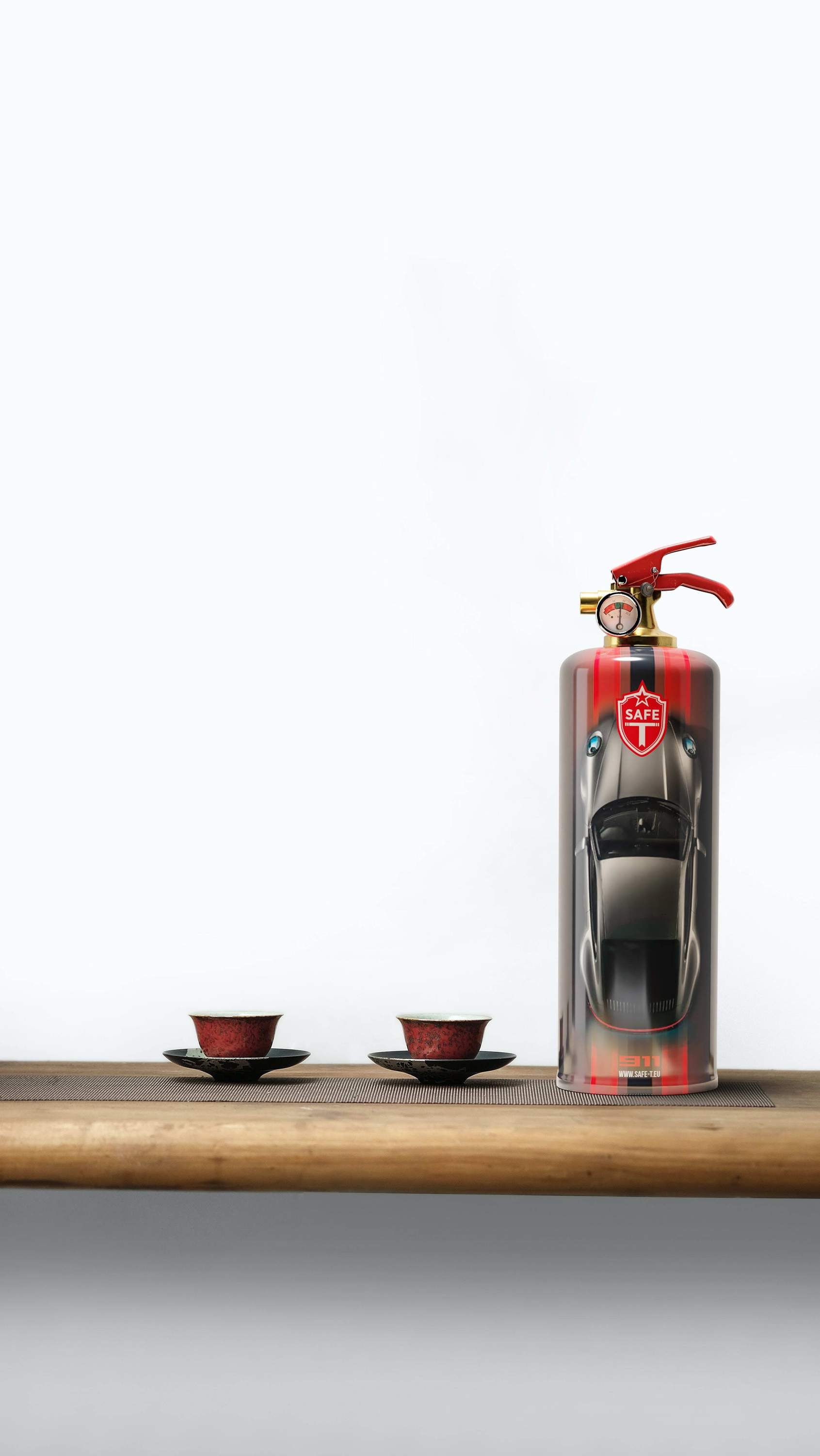 The 911 Classic fire extinguisher, a stylish and functional safety device made of steel and brass, elegantly designed for home decor.