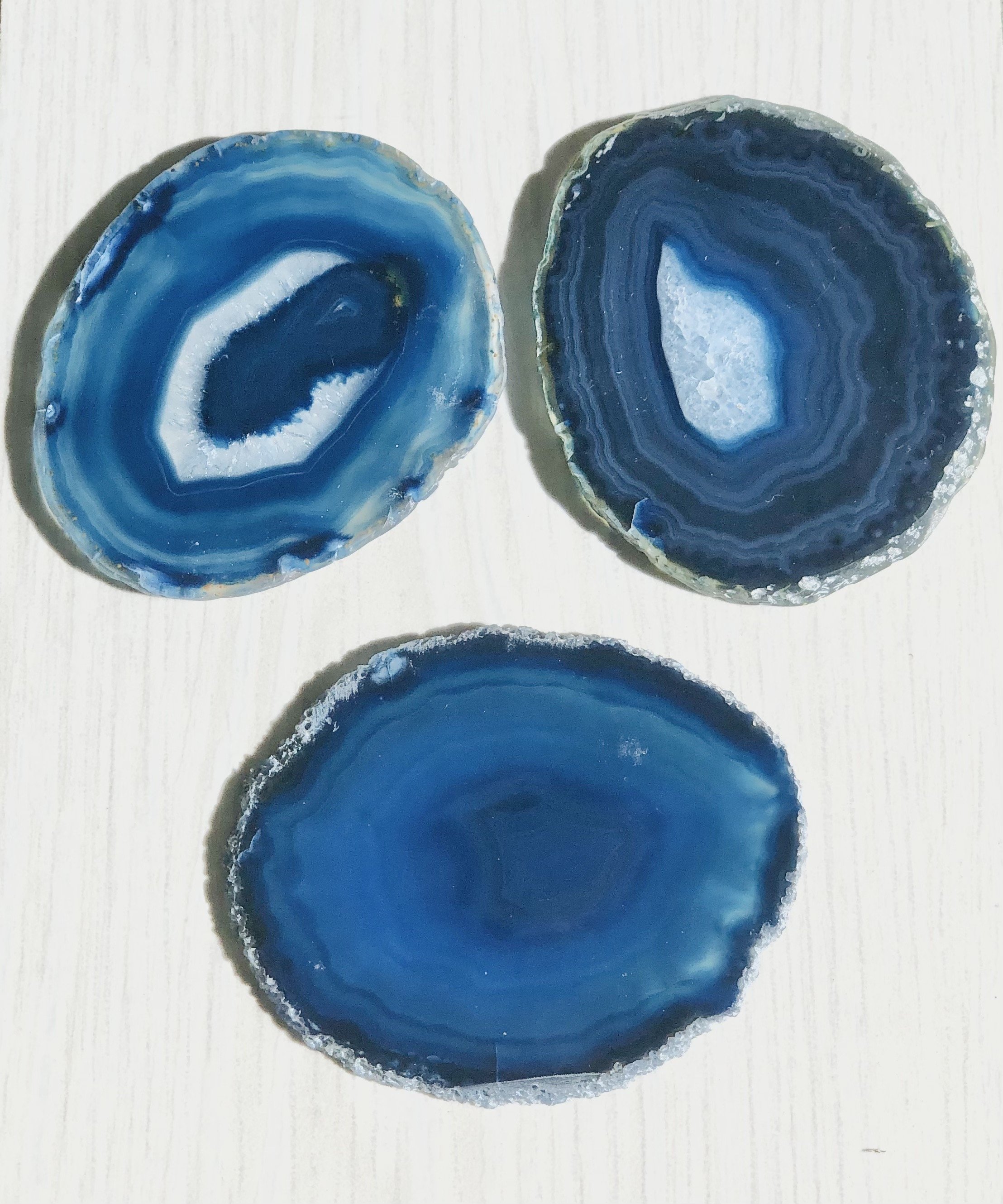 A set of four unique Agate Slice Coasters showcasing vibrant colors and natural patterns, perfect for home decor.