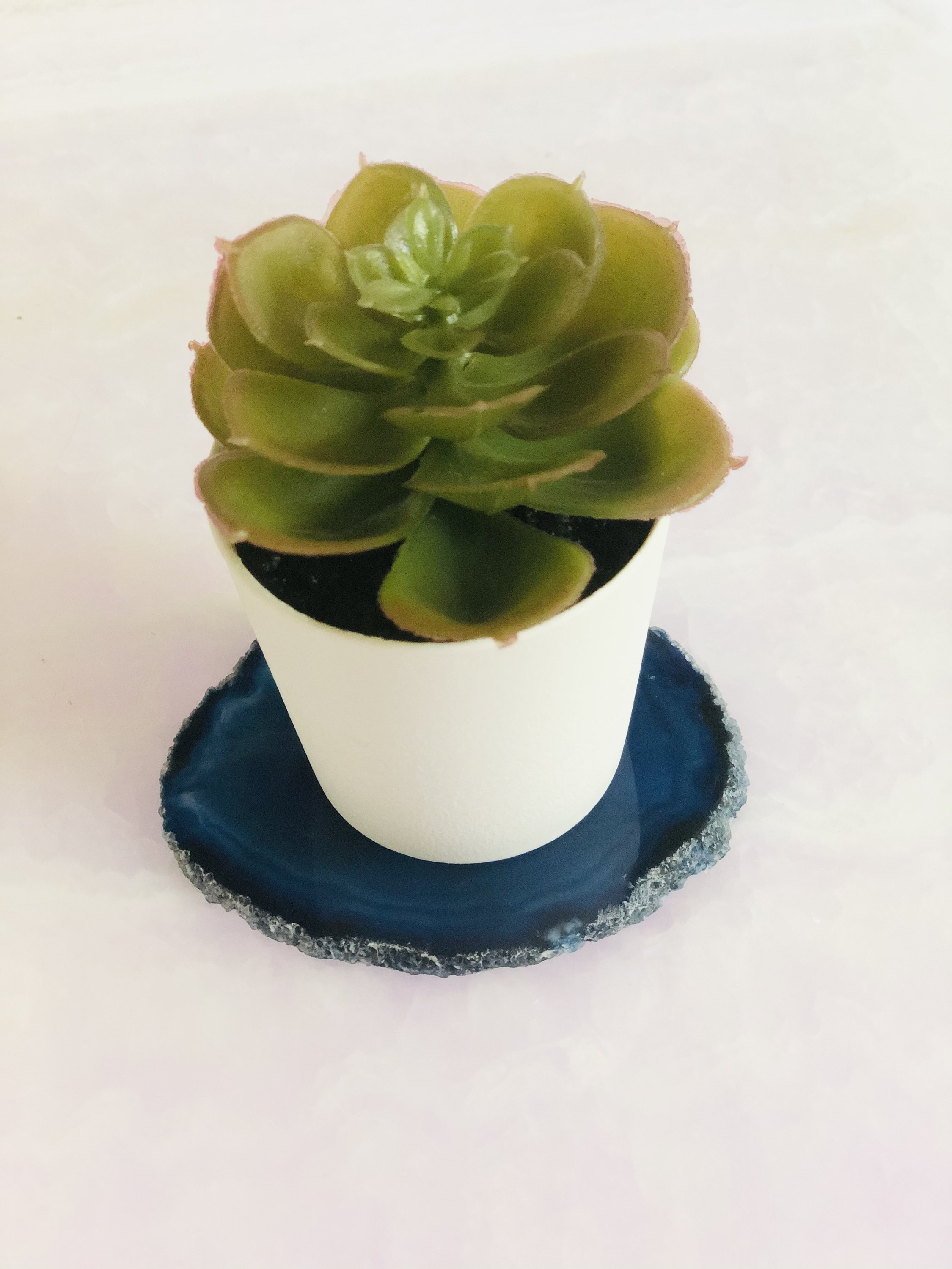 A set of four unique Agate Slice Coasters showcasing vibrant colors and natural patterns, perfect for home decor.