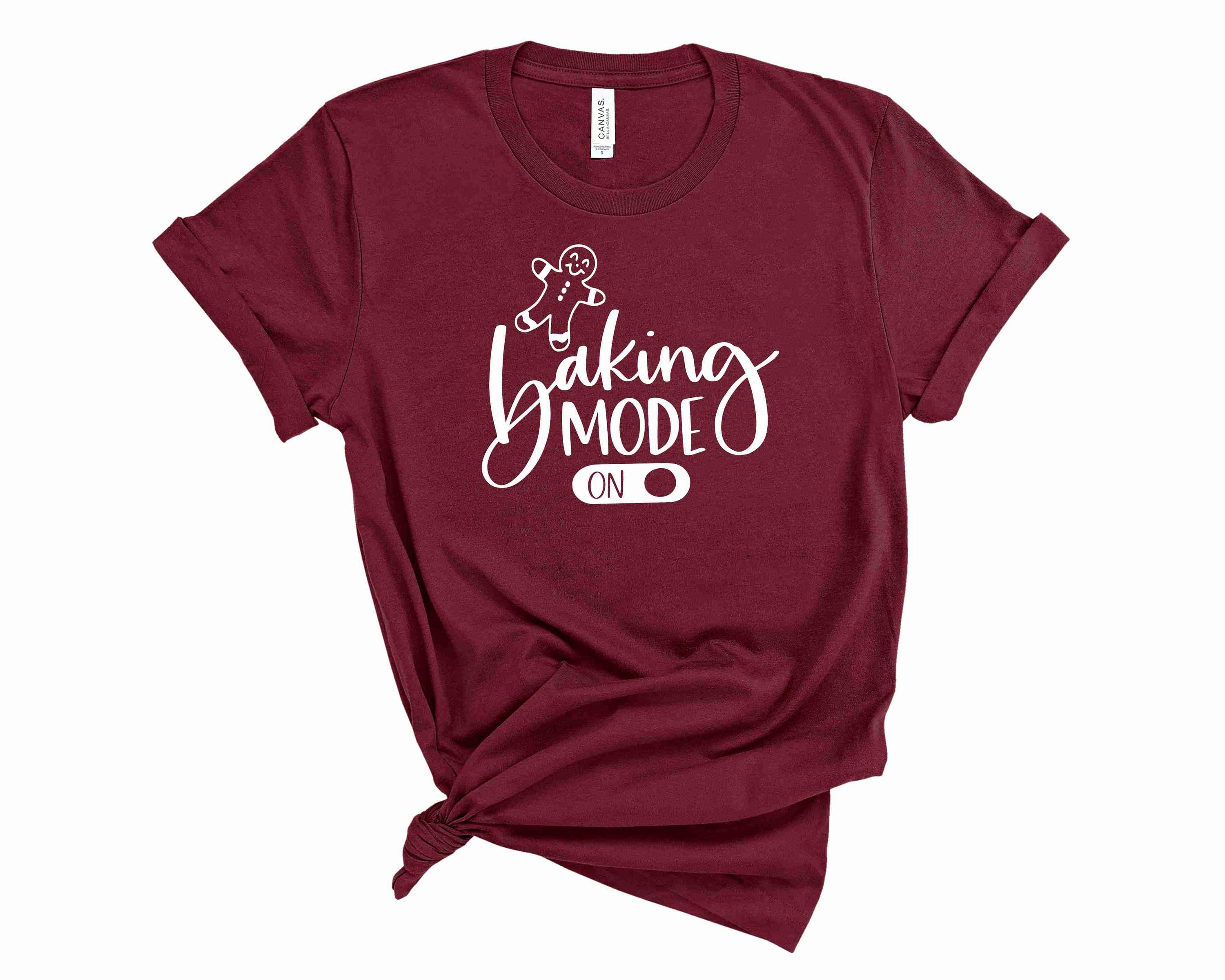A unisex graphic tee featuring the phrase 'Baking Mode On' in a stylish font, perfect for baking enthusiasts.