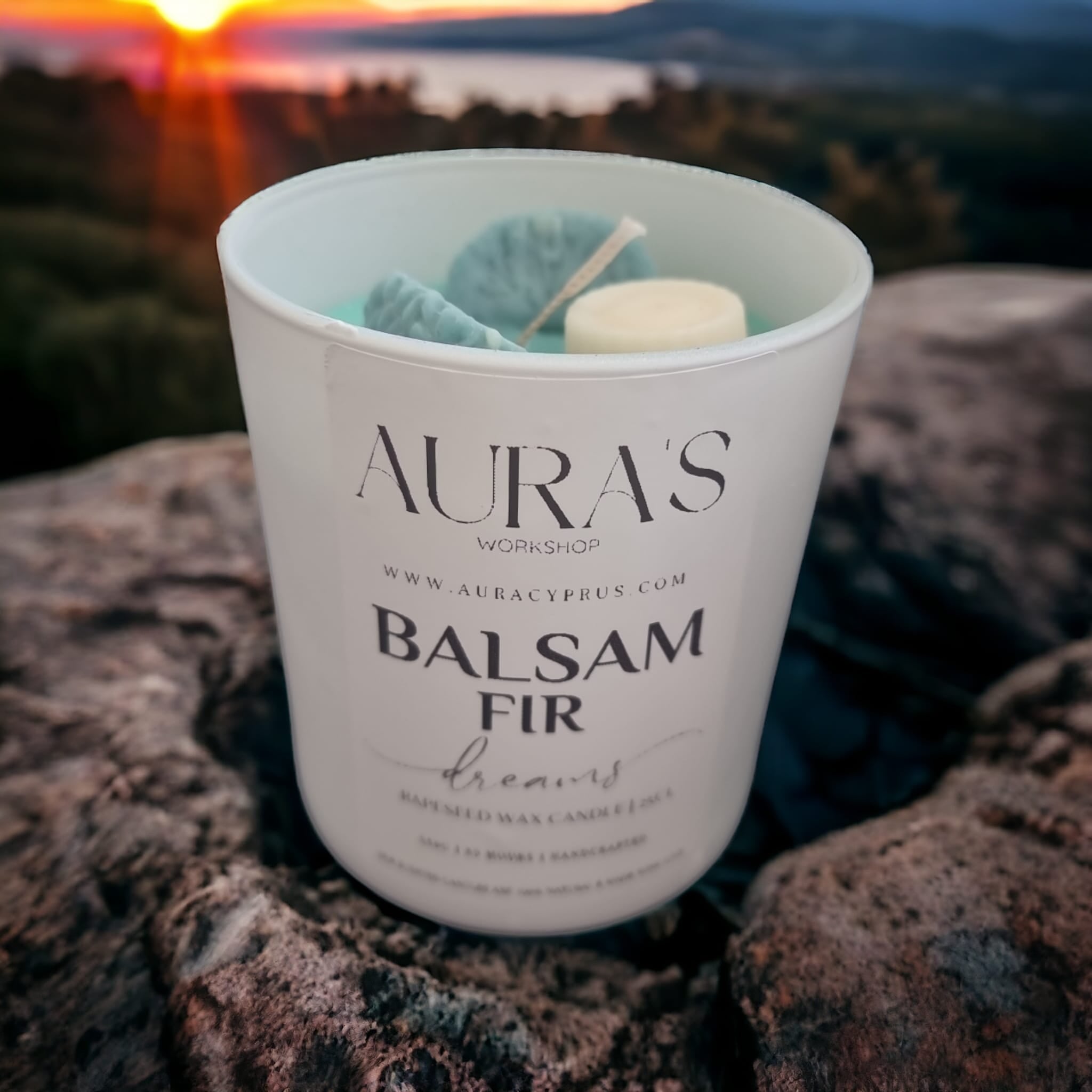 Balsam Fir Dreams Scent Candle with a warm glow, showcasing its earthy green color and elegant design, perfect for creating a cozy ambiance.