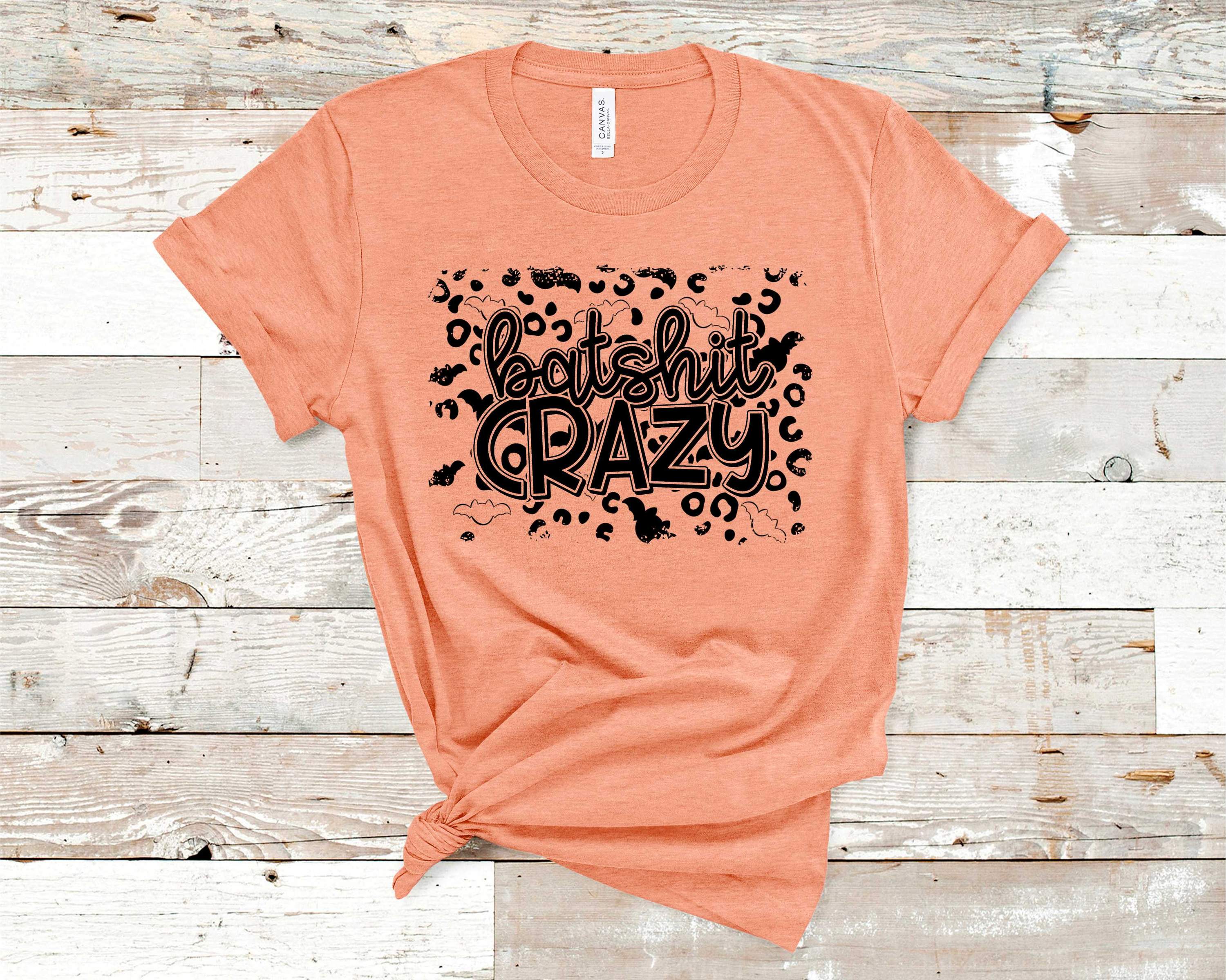 Batsh*t Crazy Graphic Tee featuring bold text on a soft Bella Canvas fabric, suitable for unisex wear.
