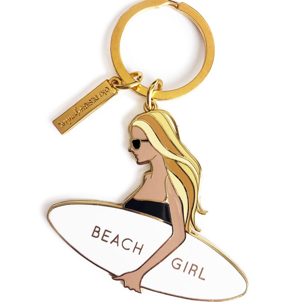 A vibrant blonde-haired surfer girl keychain made of hard enamel, showcasing a stylish design perfect for beach lovers.