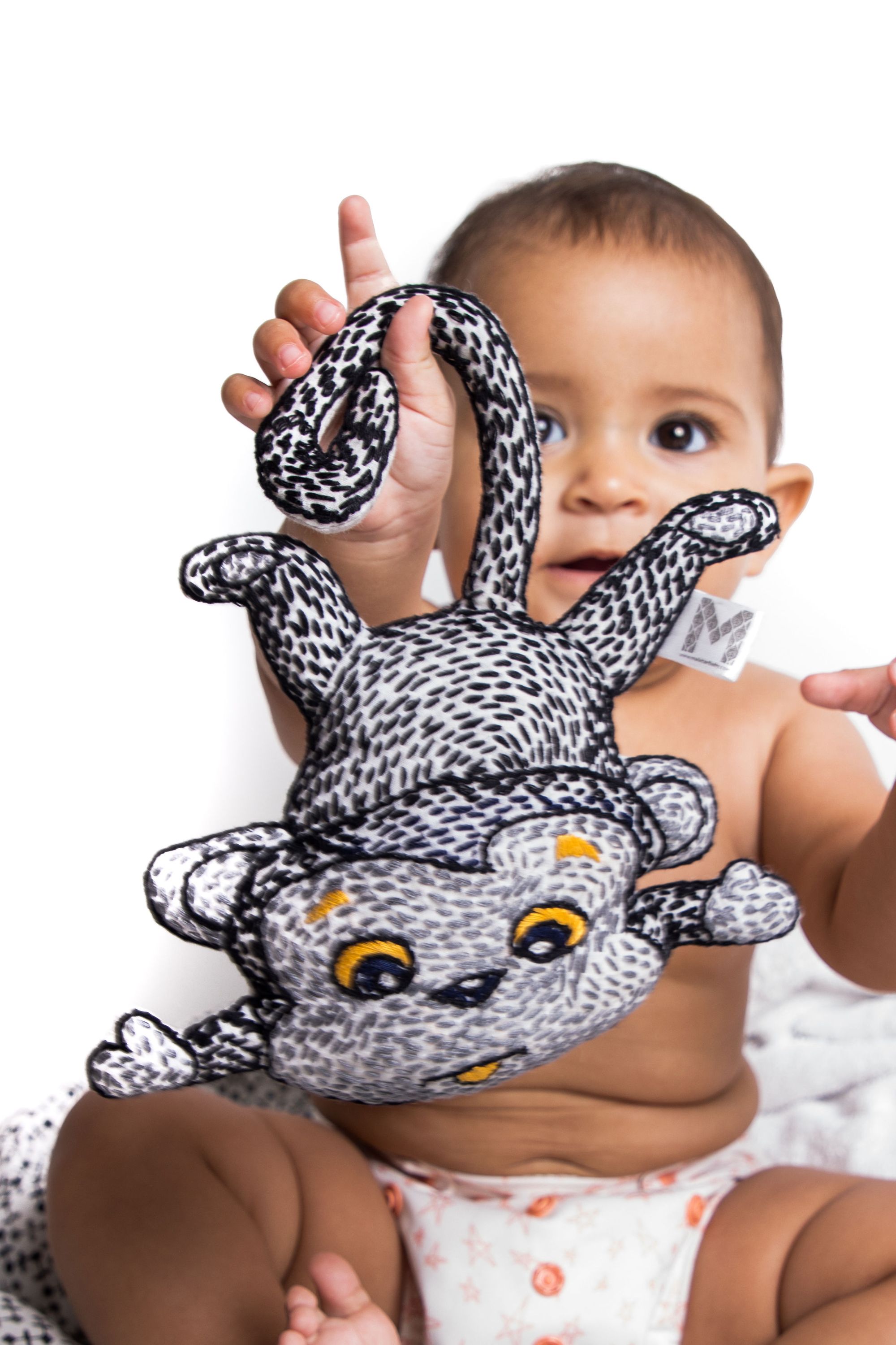 A handcrafted plush toy of Mani the Monkey, featuring vibrant colors and traditional Kantha stitching, perfect for children's nurseries.