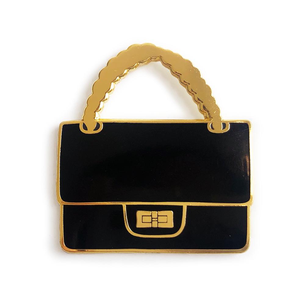 Black Chain Bag Fashion Enamel Pin with glossy finish, featuring a stylish design, perfect for accessorizing bags and jackets.