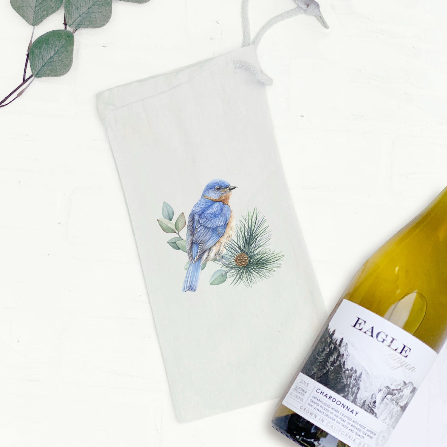 Blue Bird Canvas Wine Bag featuring a whimsical bird design, made from durable cotton canvas with a drawstring closure.