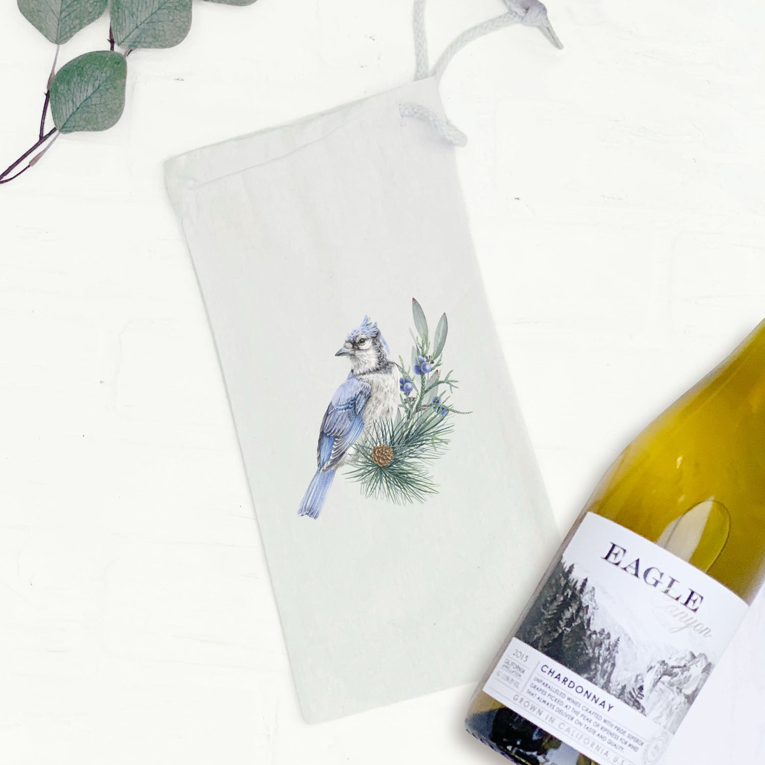 Blue Jay Canvas Wine Bag featuring a vibrant bird design, made from 100% cotton canvas with a drawstring closure.