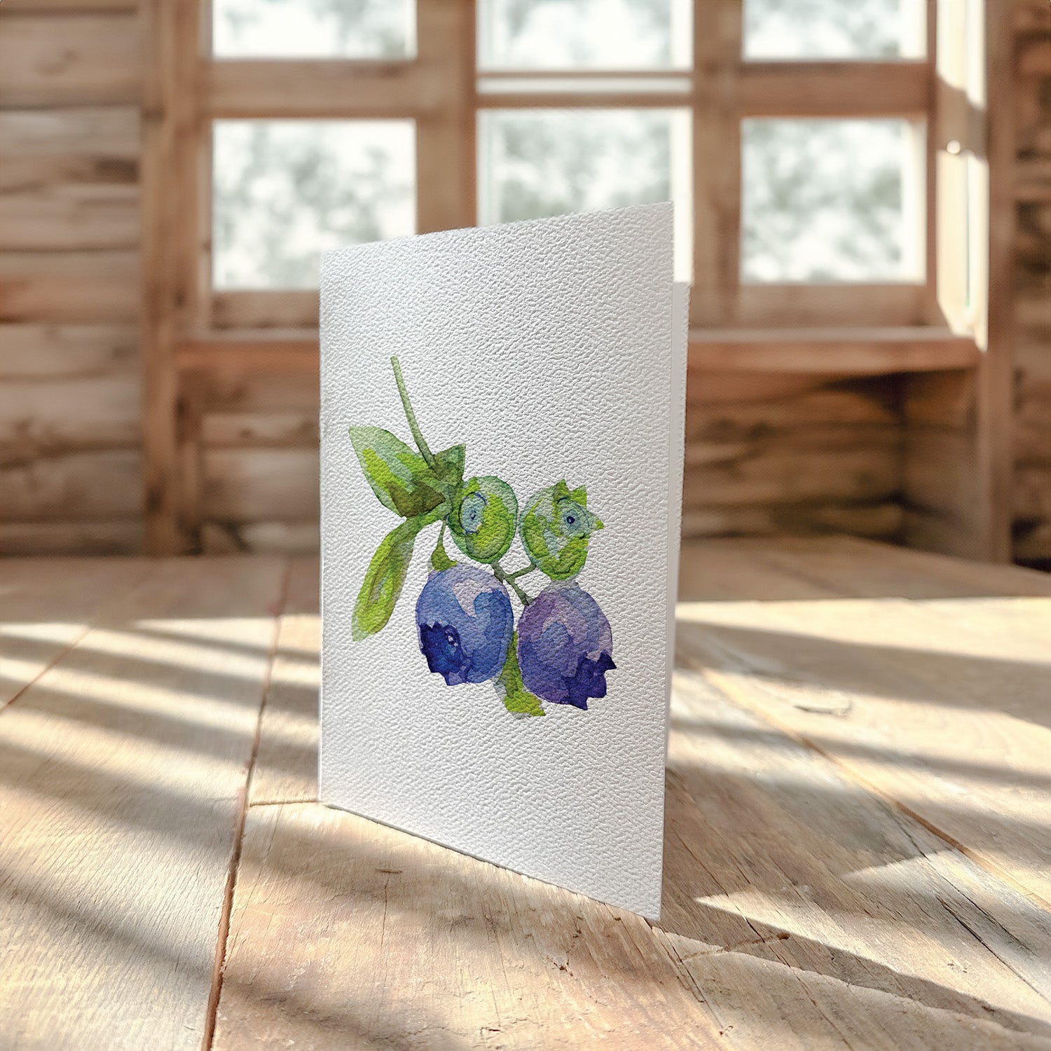 A beautifully designed greeting card featuring vibrant blueberries on a high-quality cardstock with a felt finish.