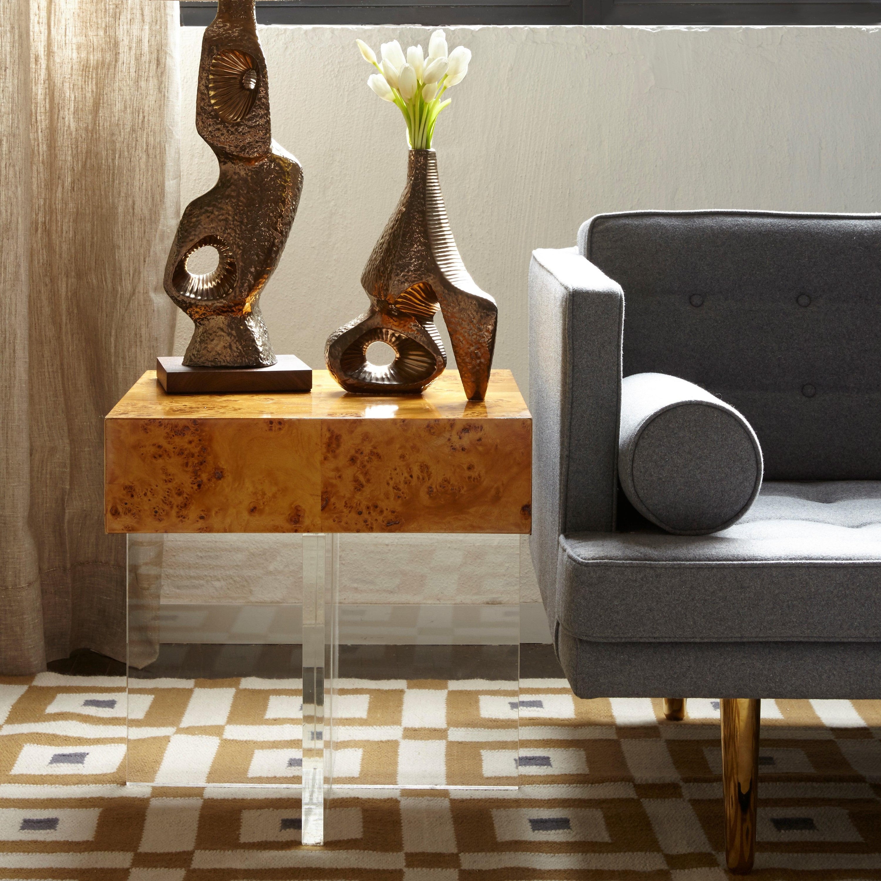 Bond End Table featuring warm burled mappa wood and a clear acrylic base, showcasing minimalist design and elegant storage.